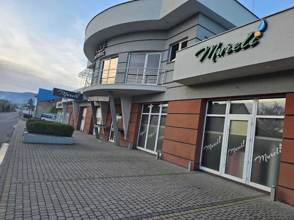 Exterior view of the Mureli leather workshop building in the Carpathians, featuring branded signage and modern design