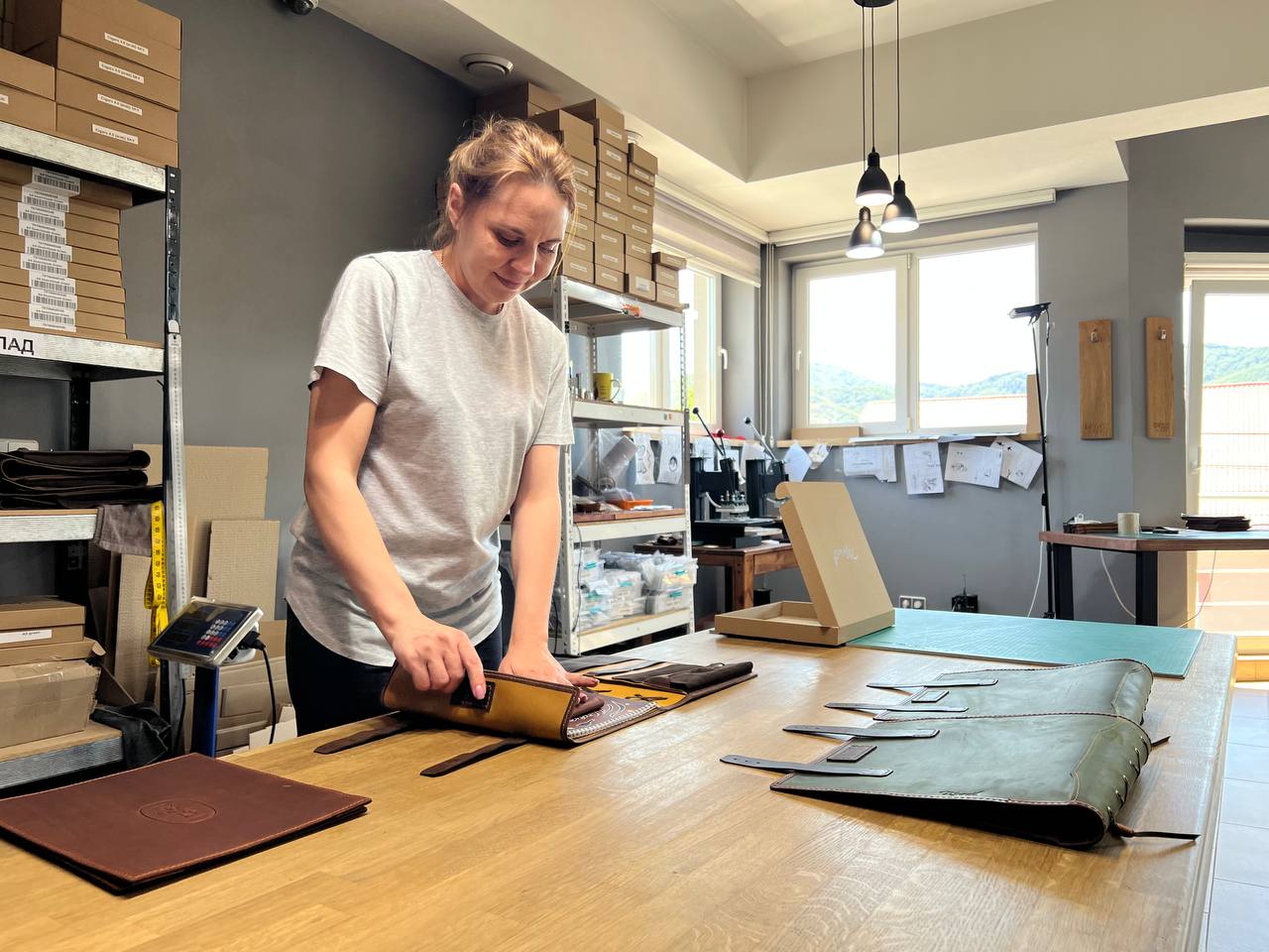 Ruslana at the Mureli workshop — our packaging specialist preparing custom boxes for handcrafted leather goods.