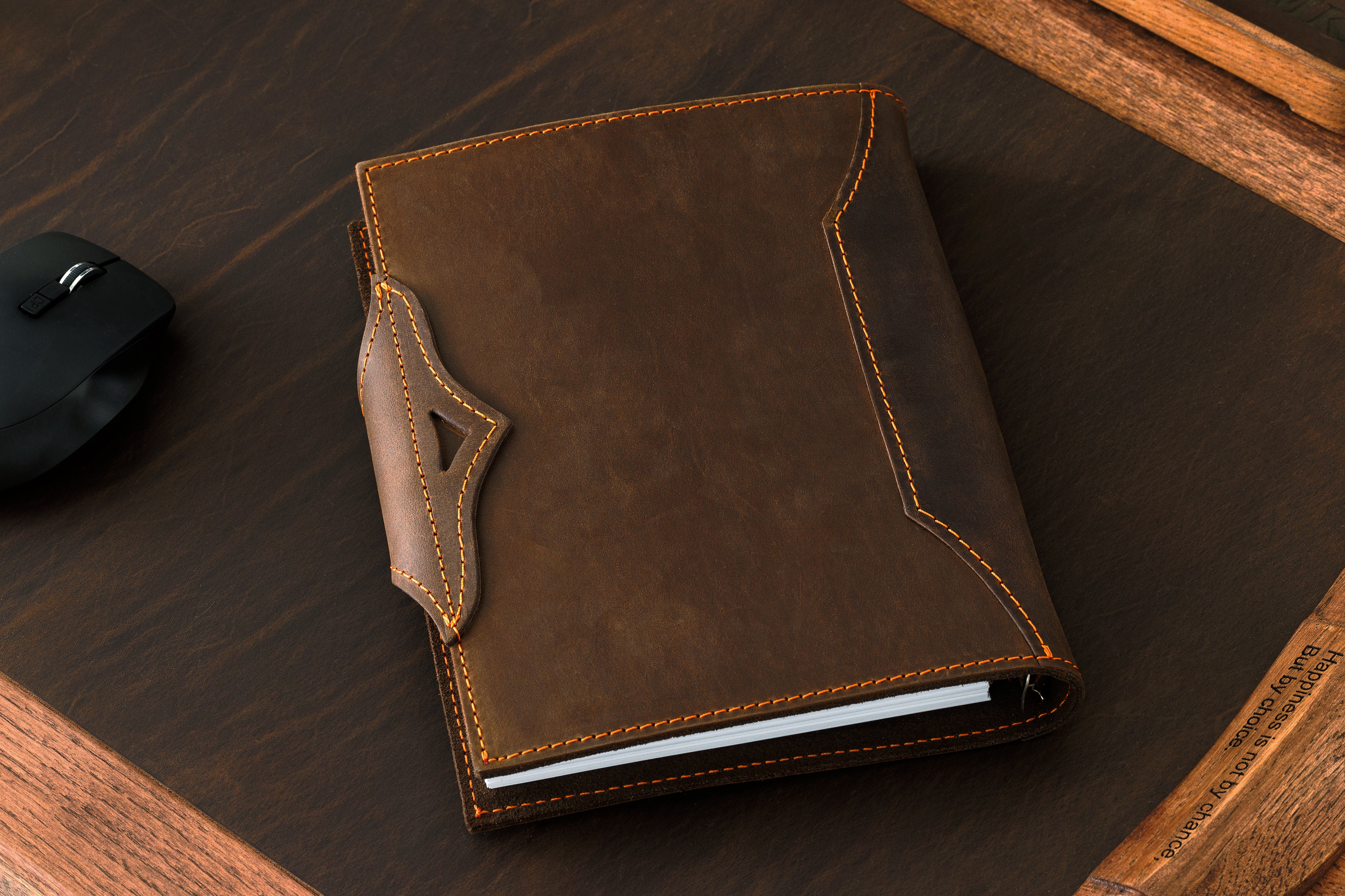 Refillable brown leather notebook by Mureli with signature tail-shaped strap