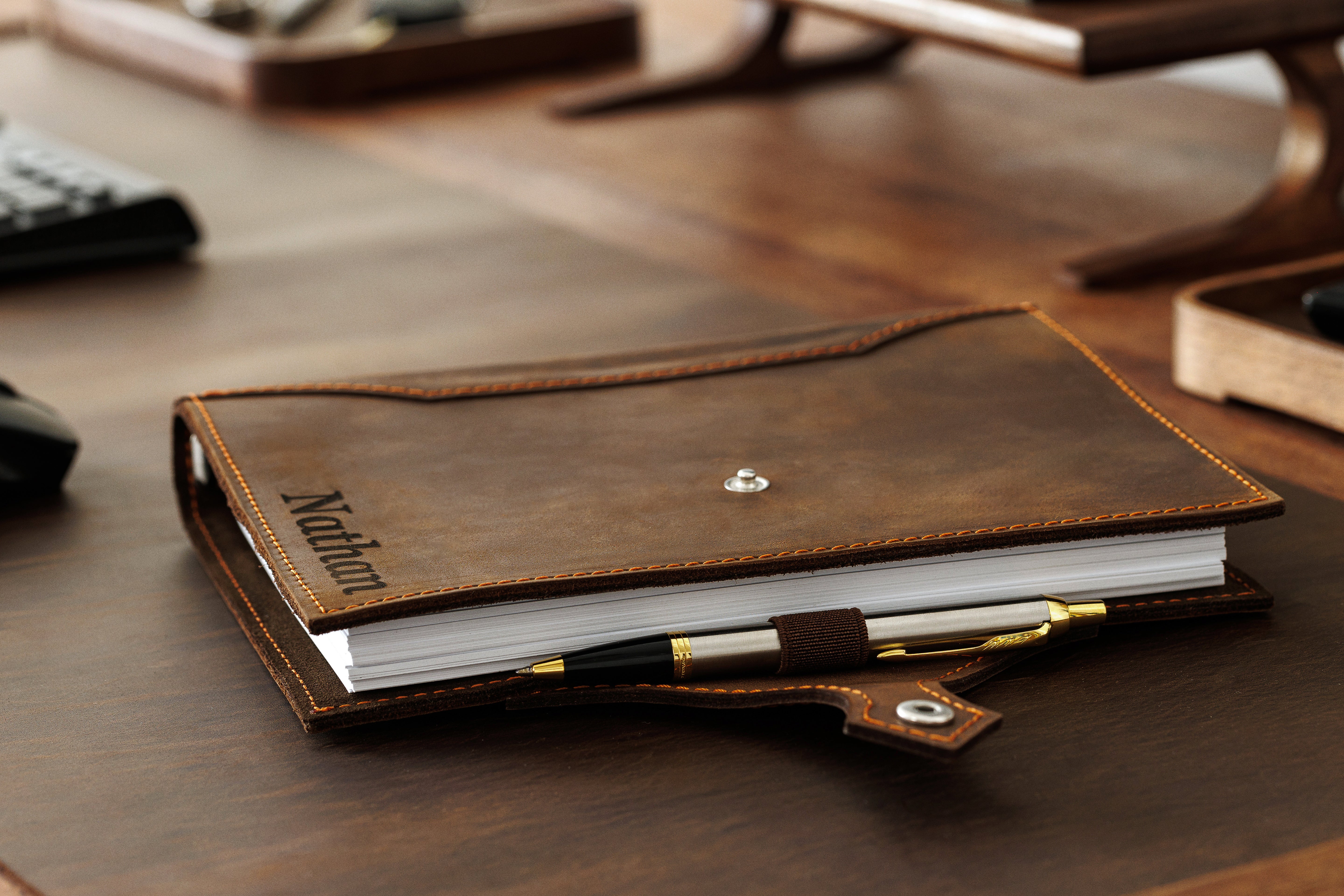 Minimalist brown notebook with handcrafted details and secure button closure