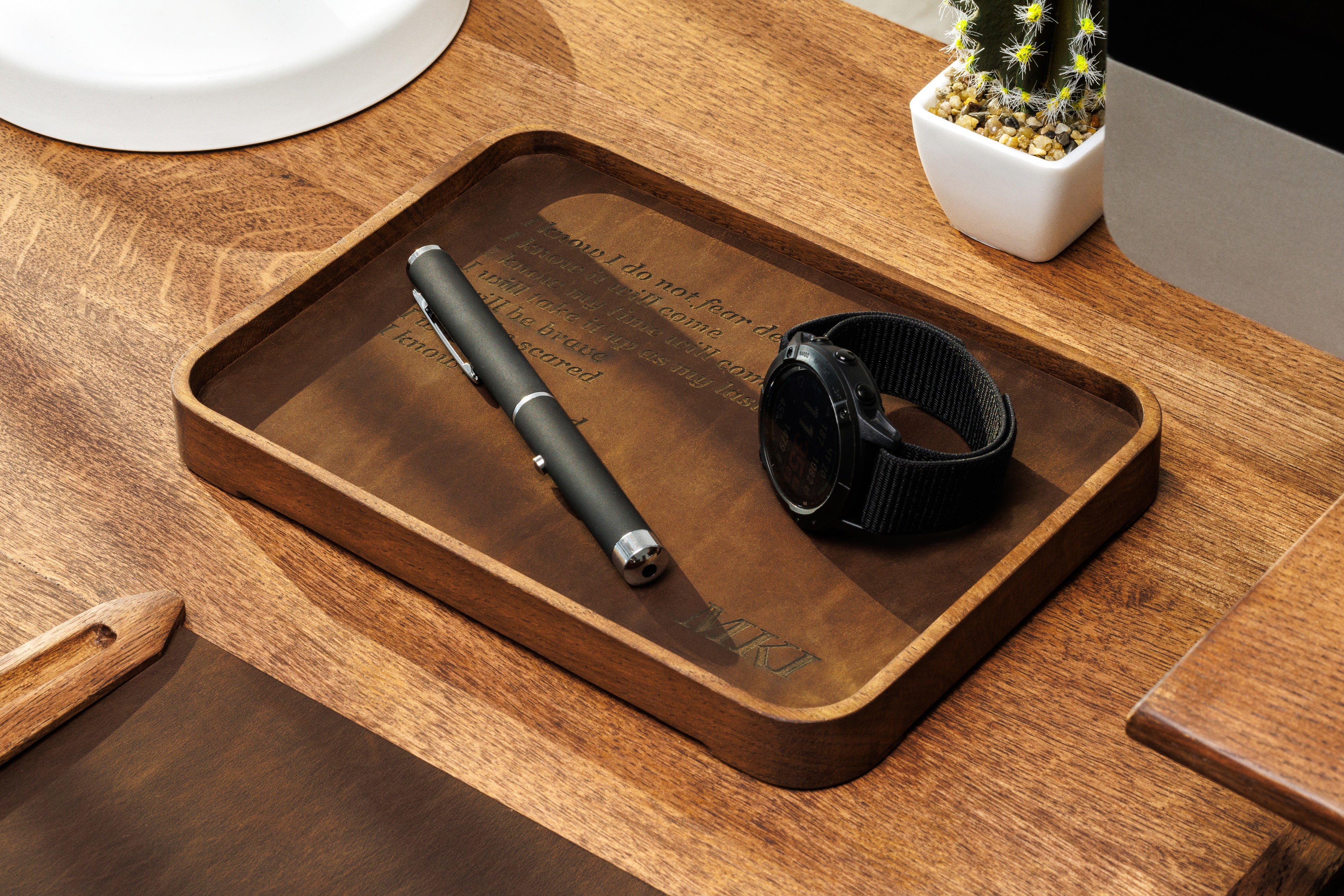 Desktop essentials arranged on premium leather tray