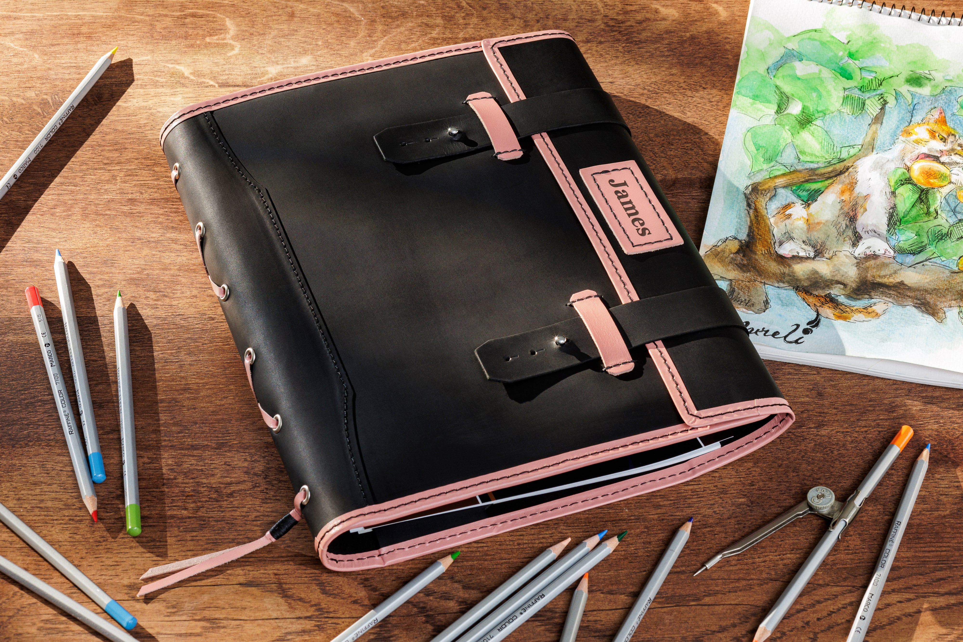 Black leather sketchbook with pink accents and personalized nameplate — handmade artist organizer by Mureli