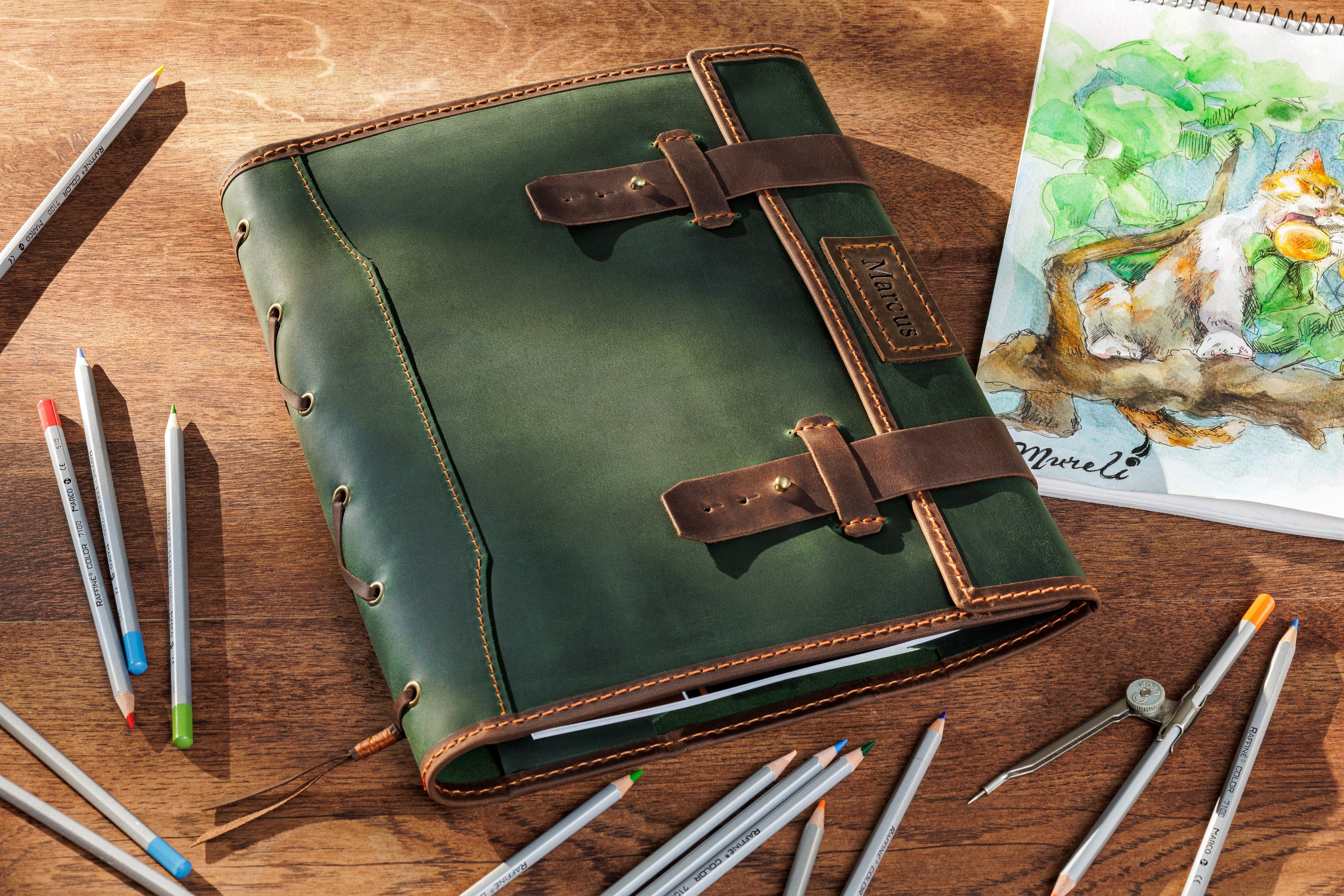 Forest green leather sketchbook organizer with brown straps and nameplate — handcrafted artist gift by Mureli