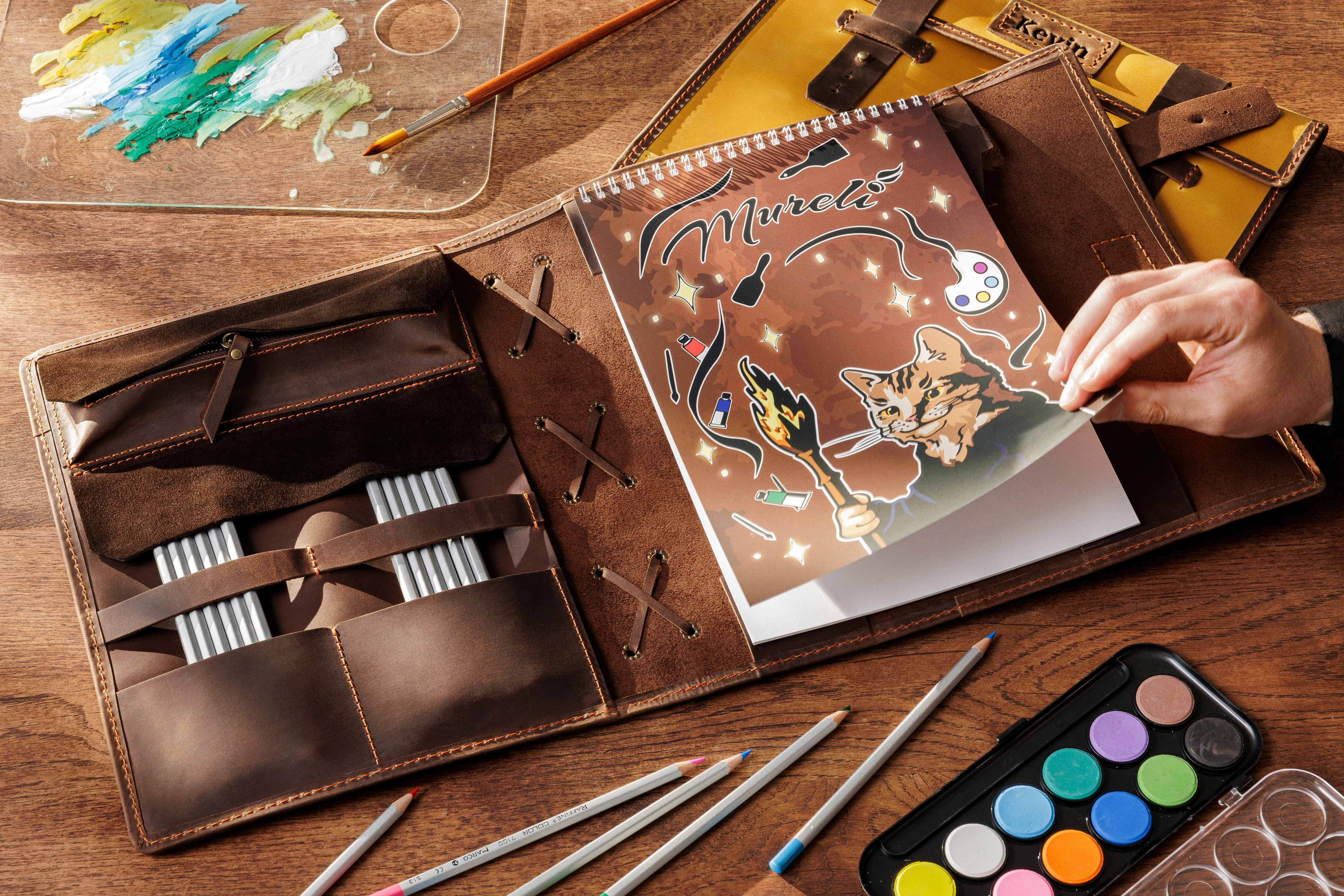 Personalized dark brown artist organizer made of Crazy Horse leather, closed with straps — perfect creative gift from Mureli
