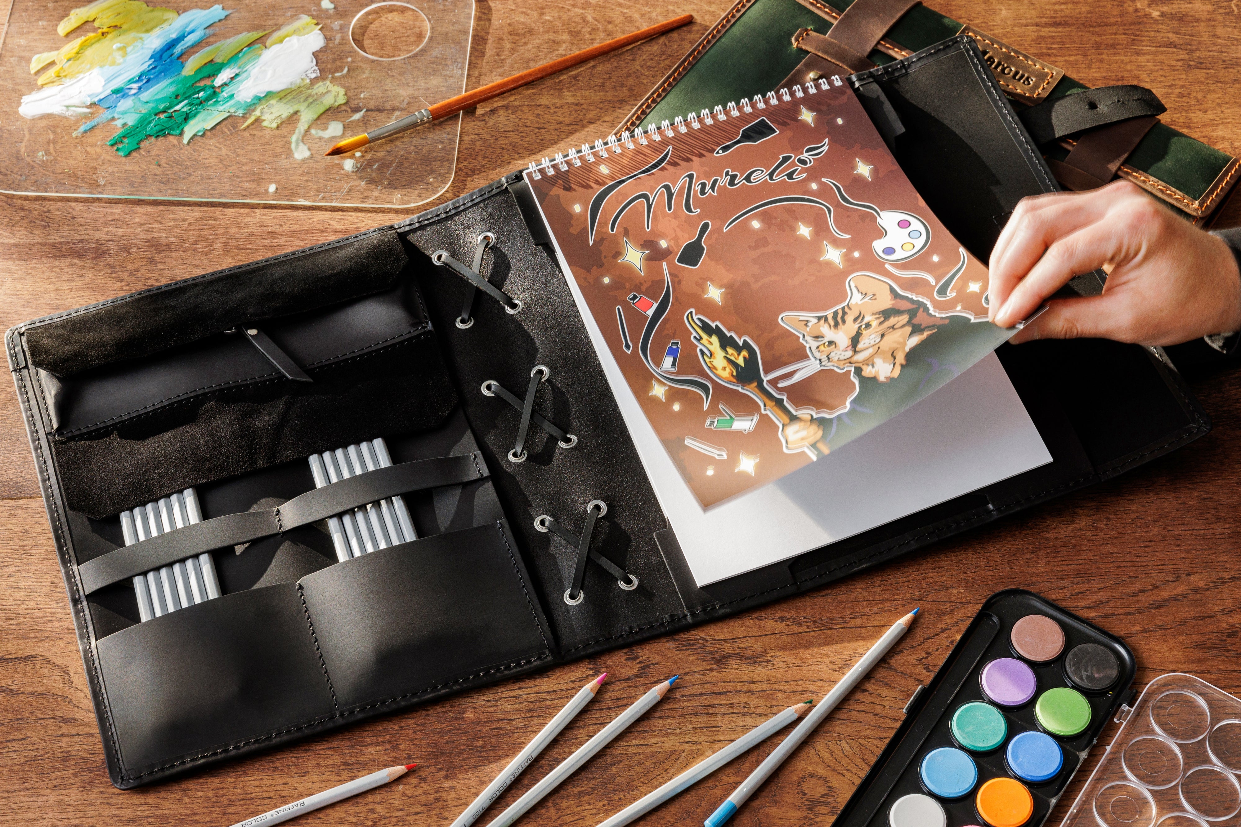 Minimalist black Crazy Horse leather artist organizer with double strap closure — handcrafted by Mureli