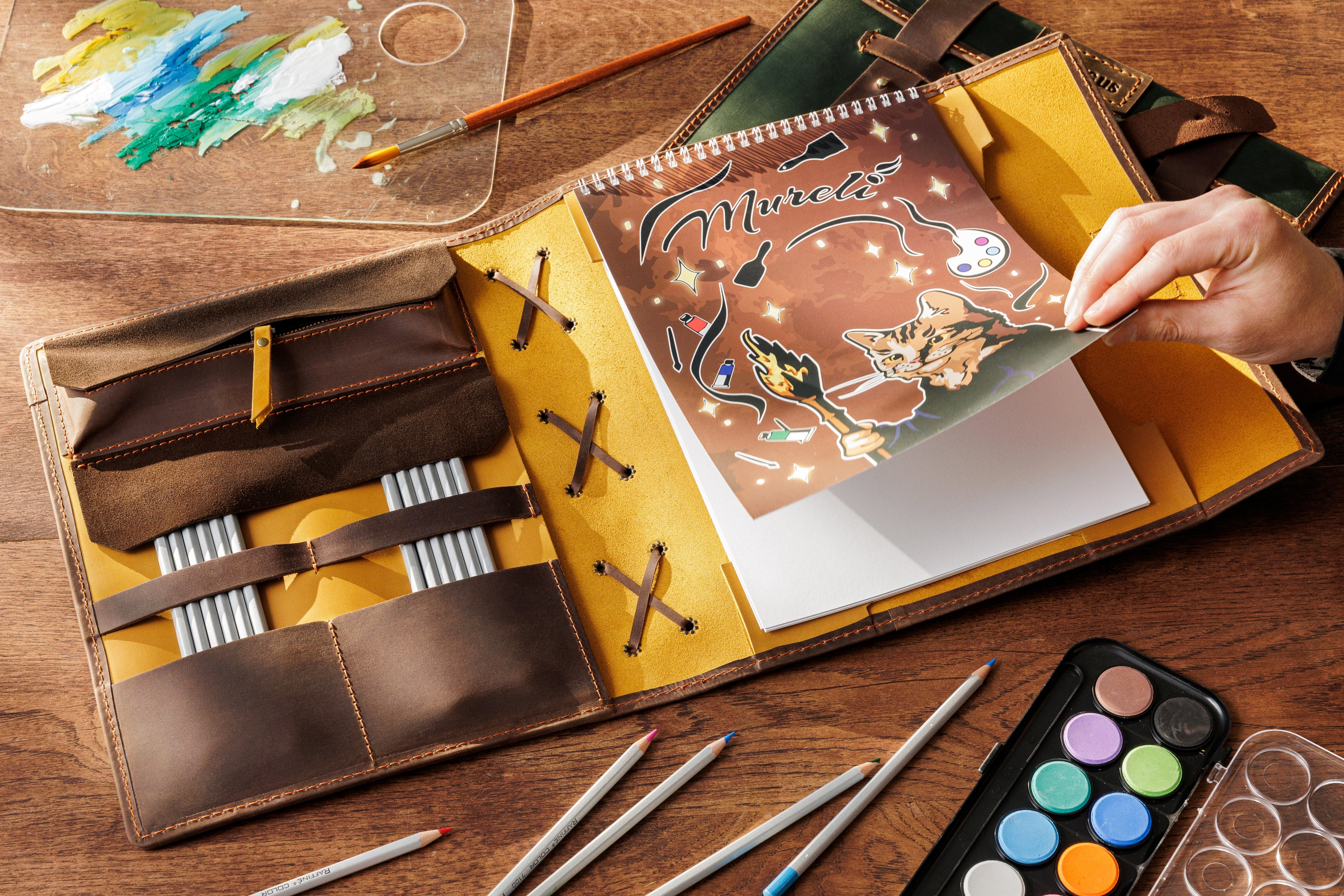 Close-up of mustard yellow leather art journal with brown strap and embossed name – La Vita collection gift