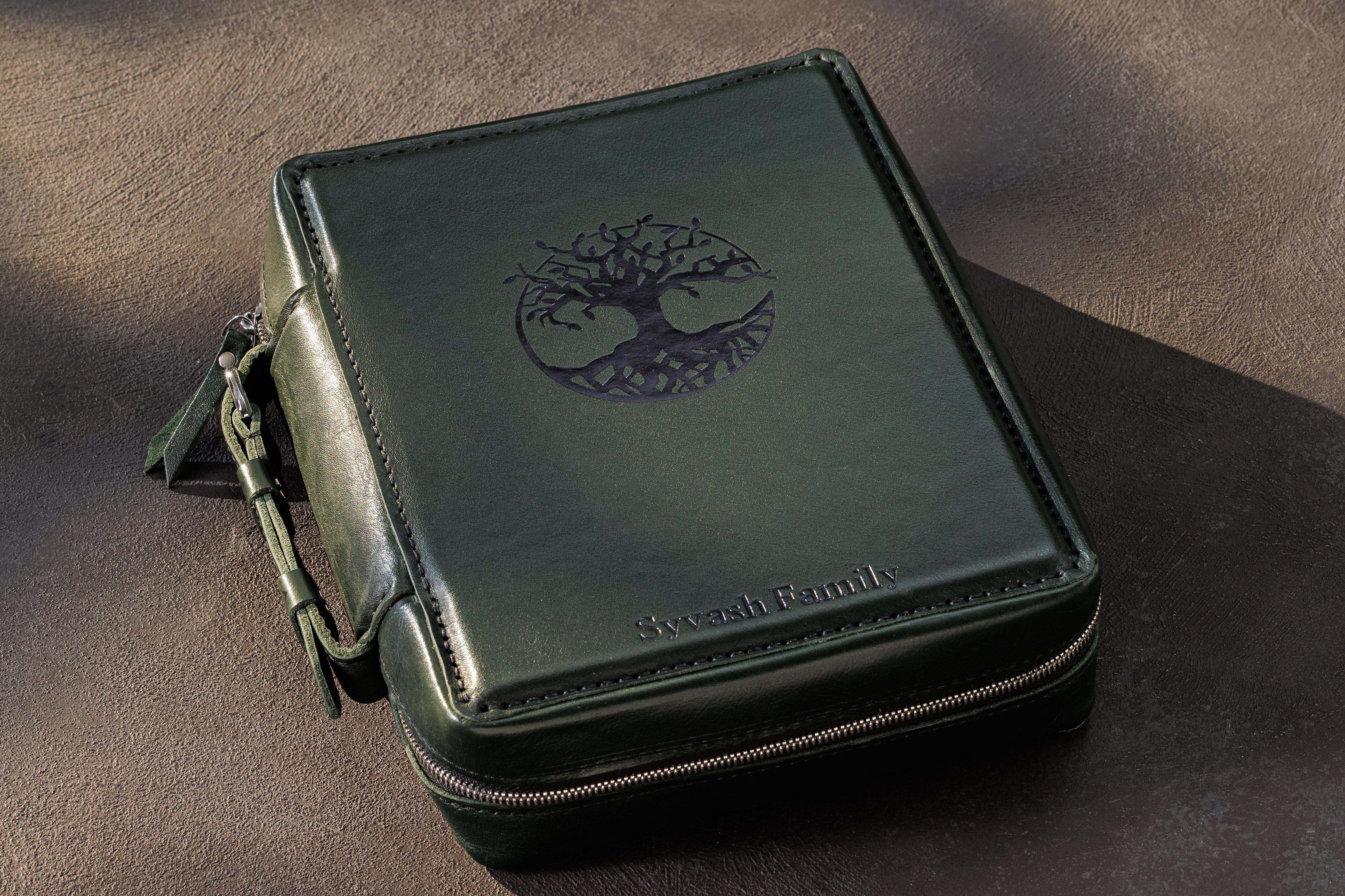 Dark green leather cash organizer with Tree of Life artwork, zip-around closure and personalized family name