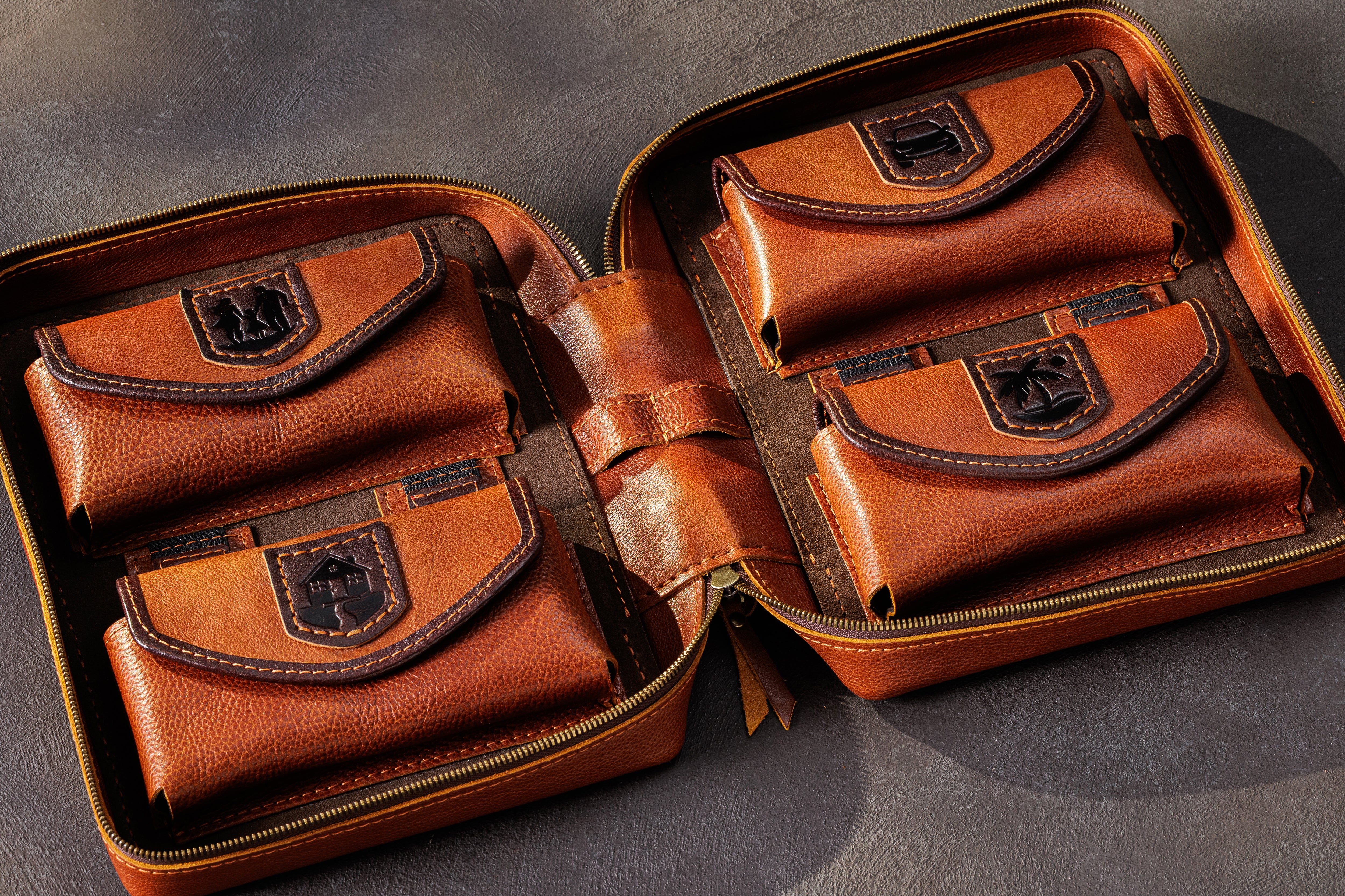 Open camel leather cash organizer with four separate bill pockets and fixed decorative patch designs