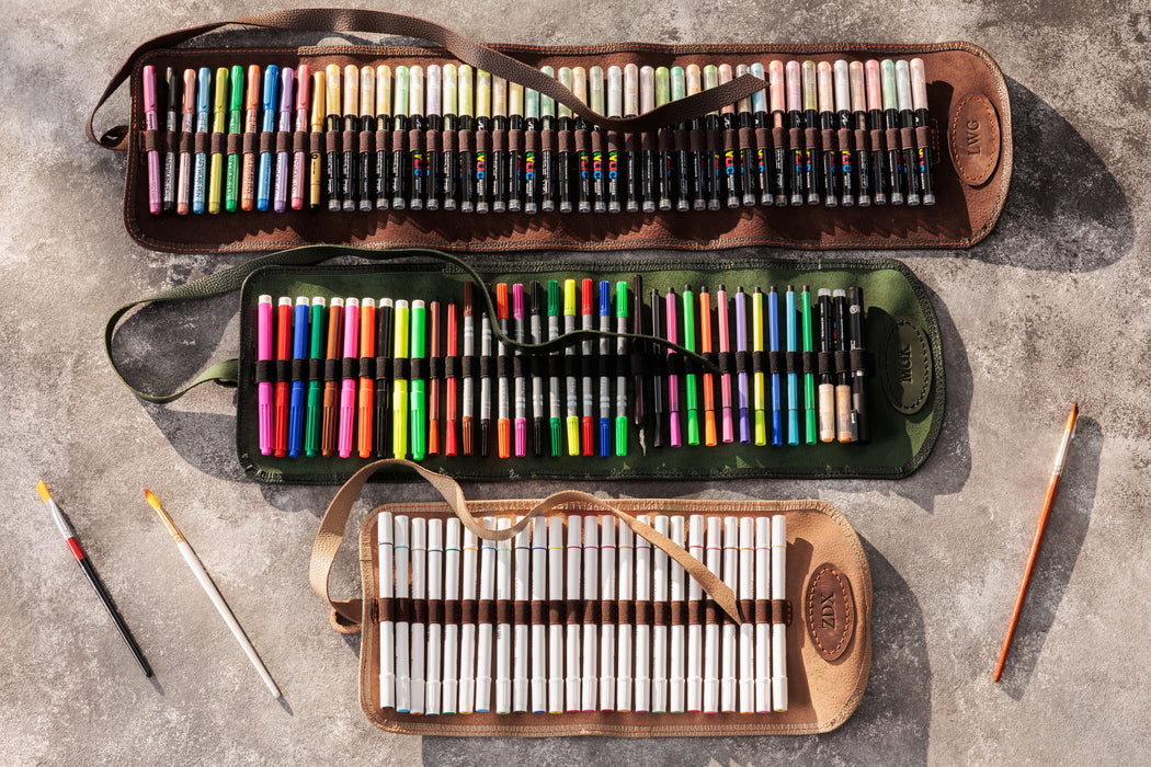 Set of colored pencils in a carrying case on a concrete surface