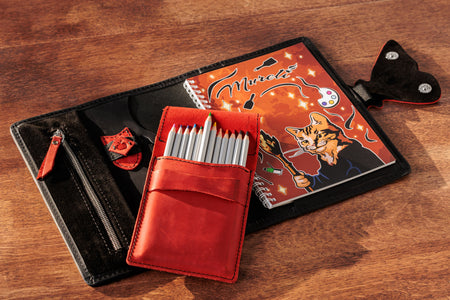 Romantic black and red leather organizer with butterfly clasp – open with sketchbook.