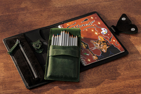 Inside view of black leather organizer with zip pocket and pen holders.
