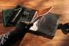 Black leather organizer with butterfly clasp – open with sketchbook.