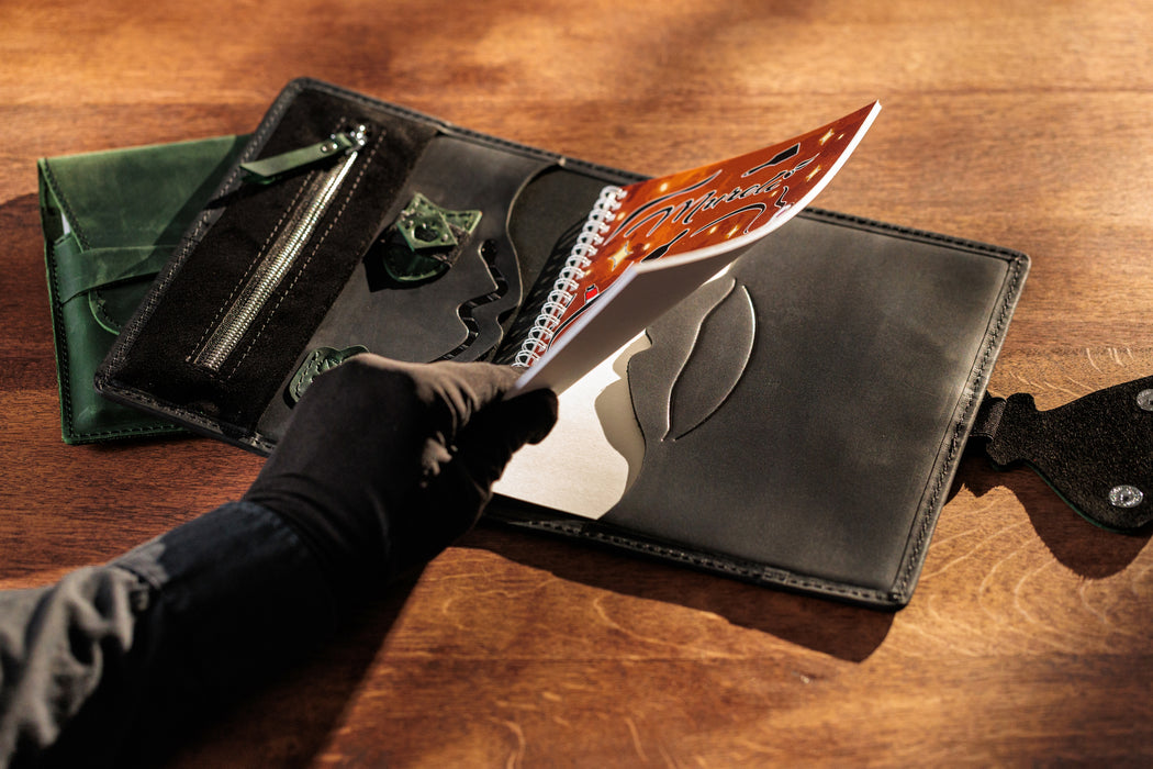 Black leather organizer with butterfly clasp – open with sketchbook.