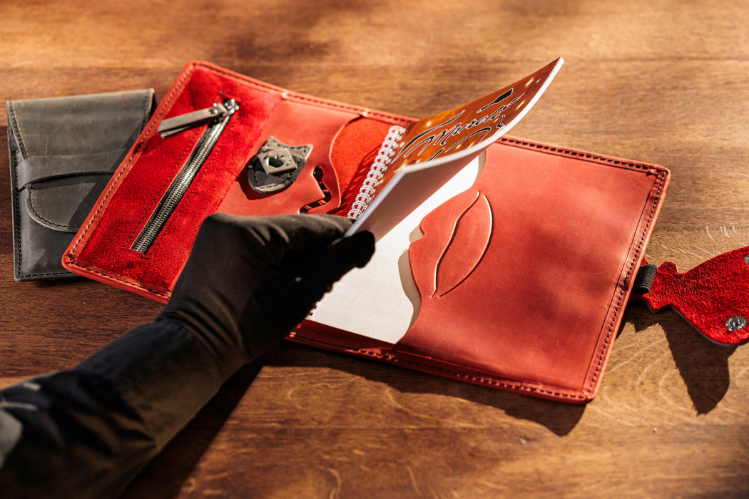 Mureli red leather organizer with butterfly clasp and multiple compartments, empty view