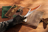 Handmade leather organizer open with spiral notebook.