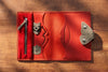 Red leather artist organizer with butterfly clasp, open with sketchbook and creative notes