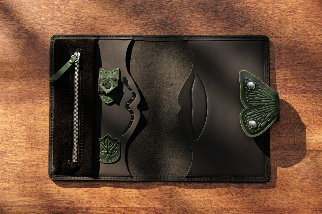 Black leather sketchbook organizer with colored pencils set.