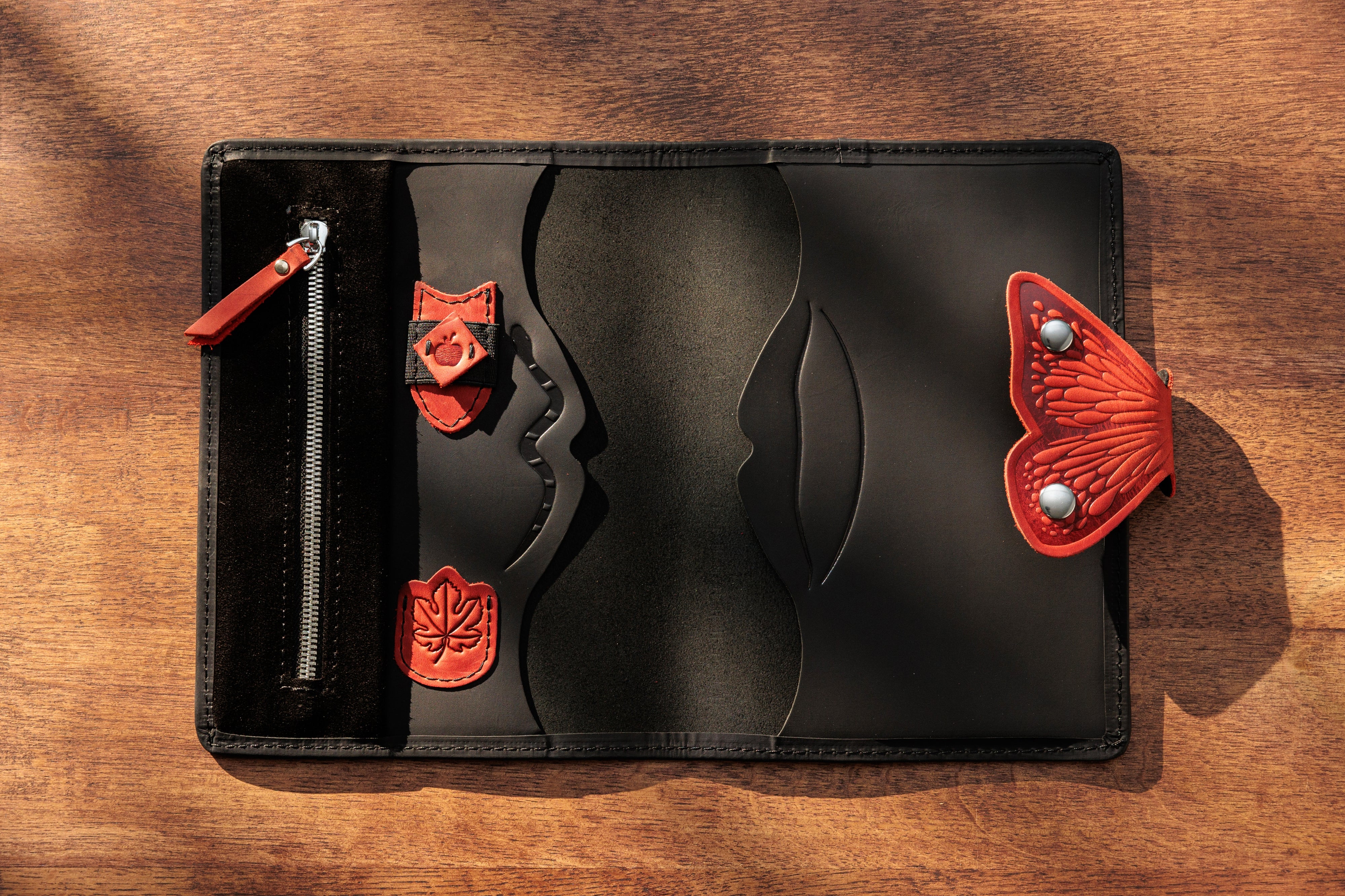 Inside black leather organizer with red details and pen holder.