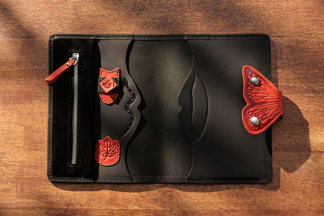 Inside black leather organizer with red details and pen holder.
