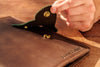 Personalized leather organizer with embossed name and butterfly clasp.