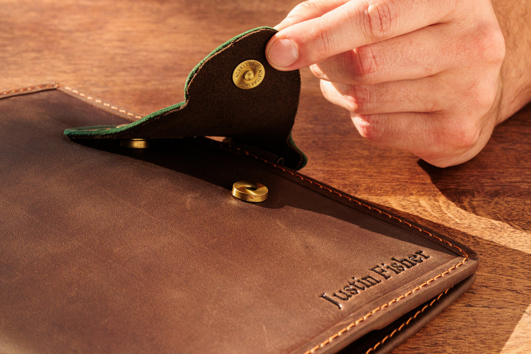 Personalized leather organizer with embossed name and butterfly clasp.