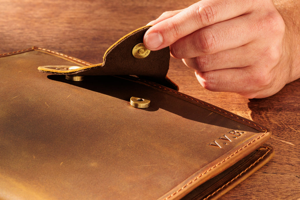Brown leather sketchbook cover with butterfly closure and personalization