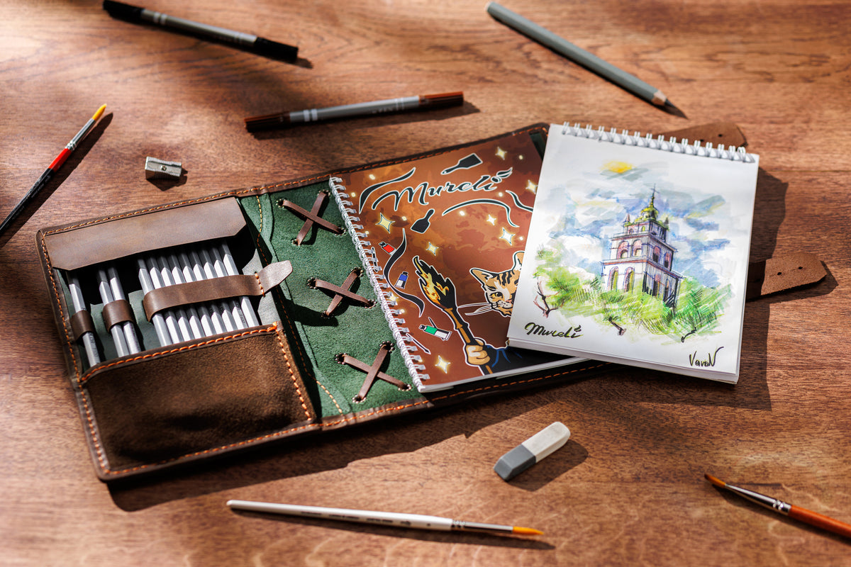 Inside olive green and brown leather sketchbook organizer with A5 and 8.5 x 5.5 notebook pocket