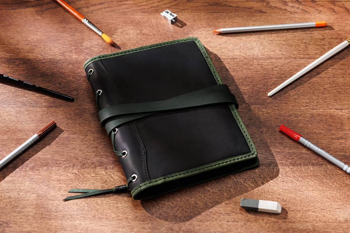 black leather A5 and 8.5 x 5.5 sketchbook organizer with olive green trim and wrap strap