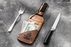 Sophisticated bottle-shaped bill folder on gray surface