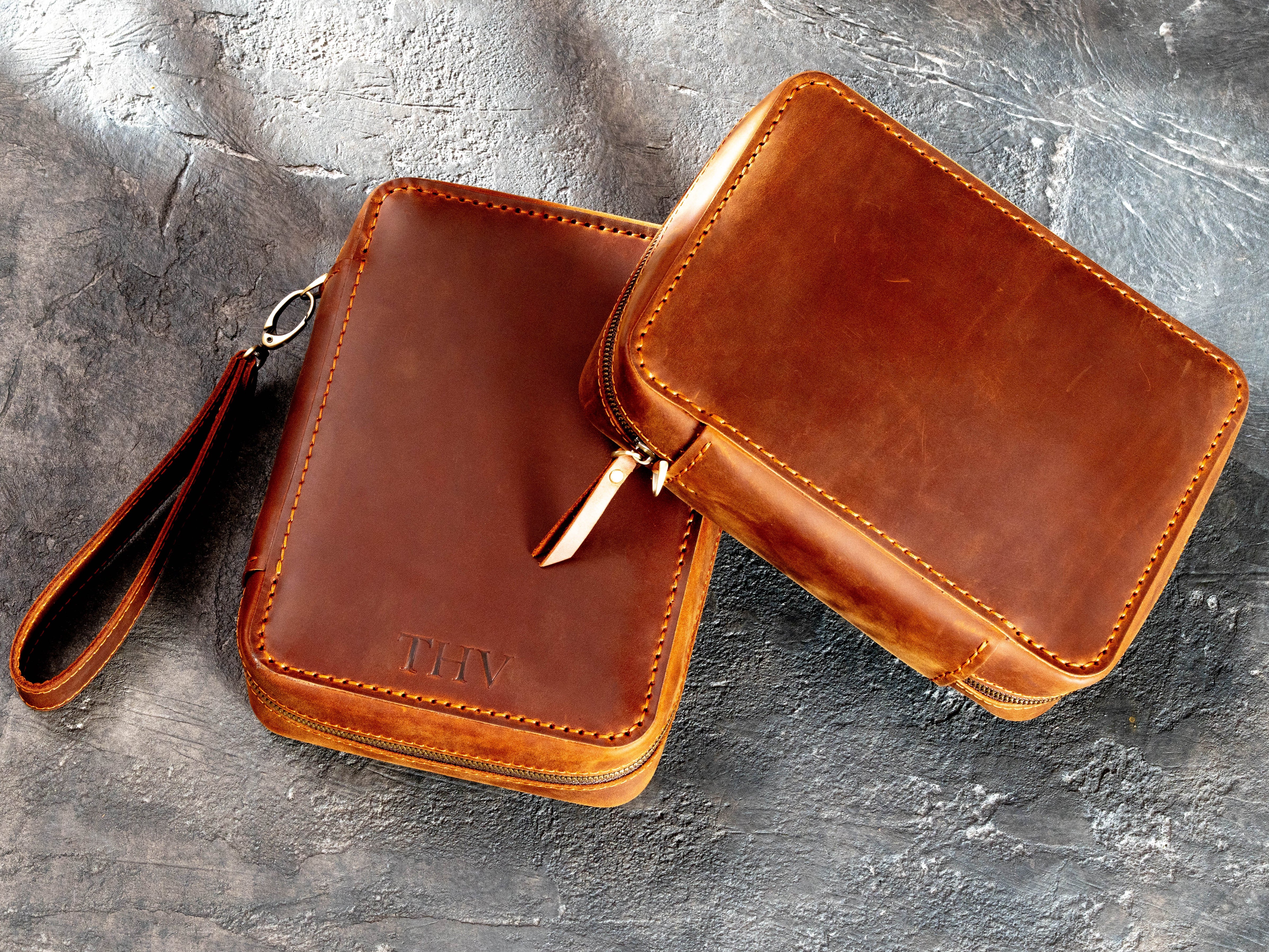 Two completed Copper Crazy Horse leather travel cases, one personalized with initials and one without personalization