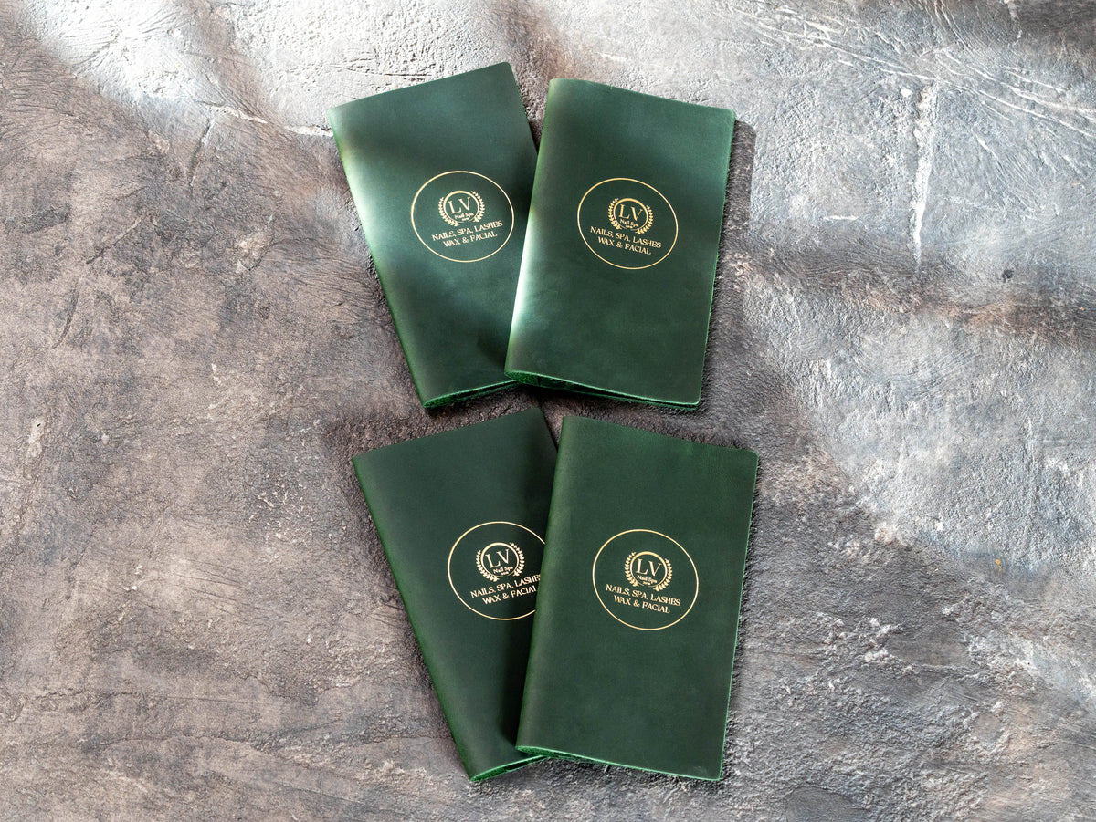 Four personalized green leather check presenters for nail salon and spa