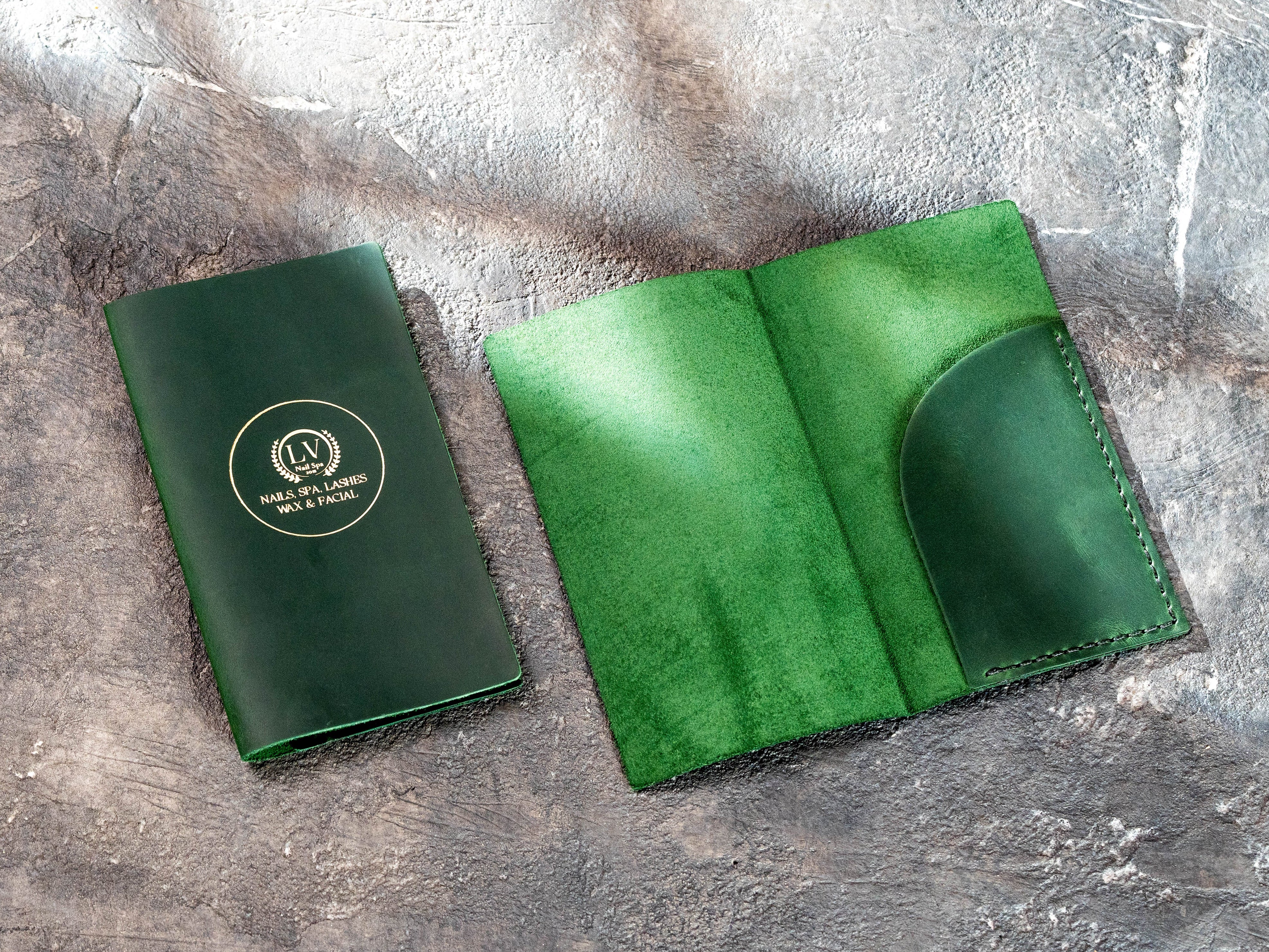 Green leather check presenters arranged in pairs with gold business logo