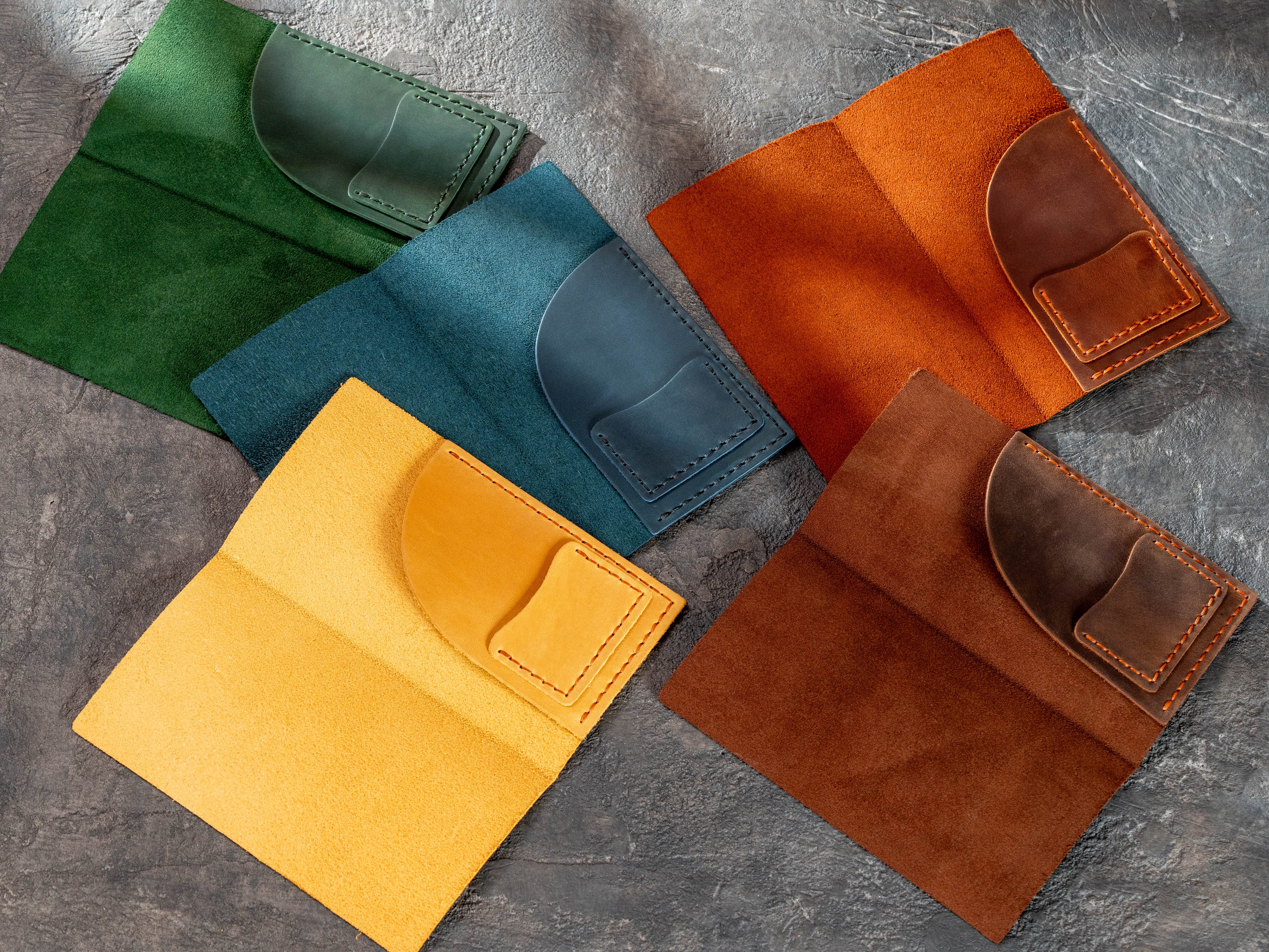 Different leather check presenter interior color options with receipt pockets and card pockets for restaurants.
