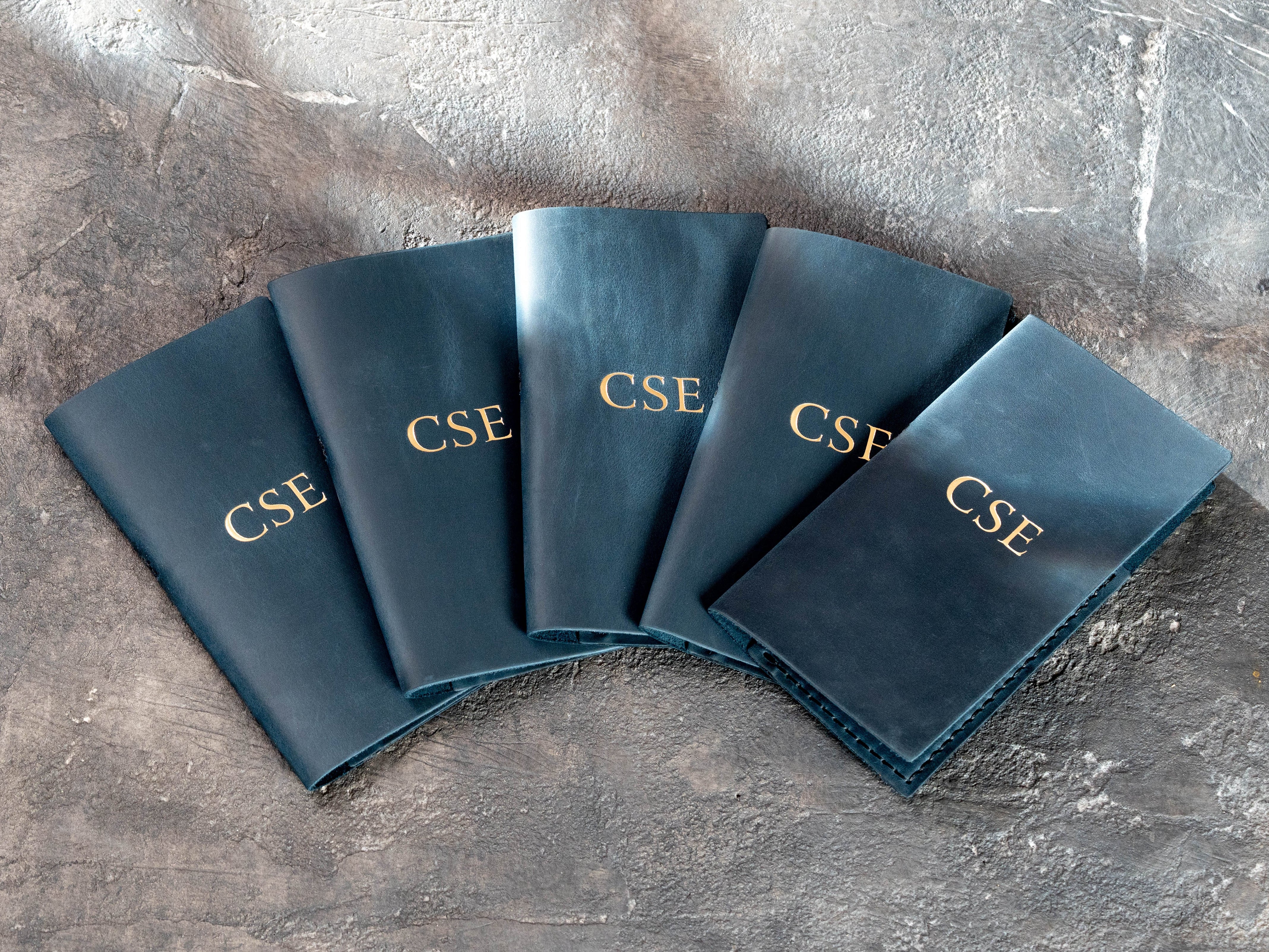 Blue leather restaurant check presenters with gold CSE personalization by Mureli