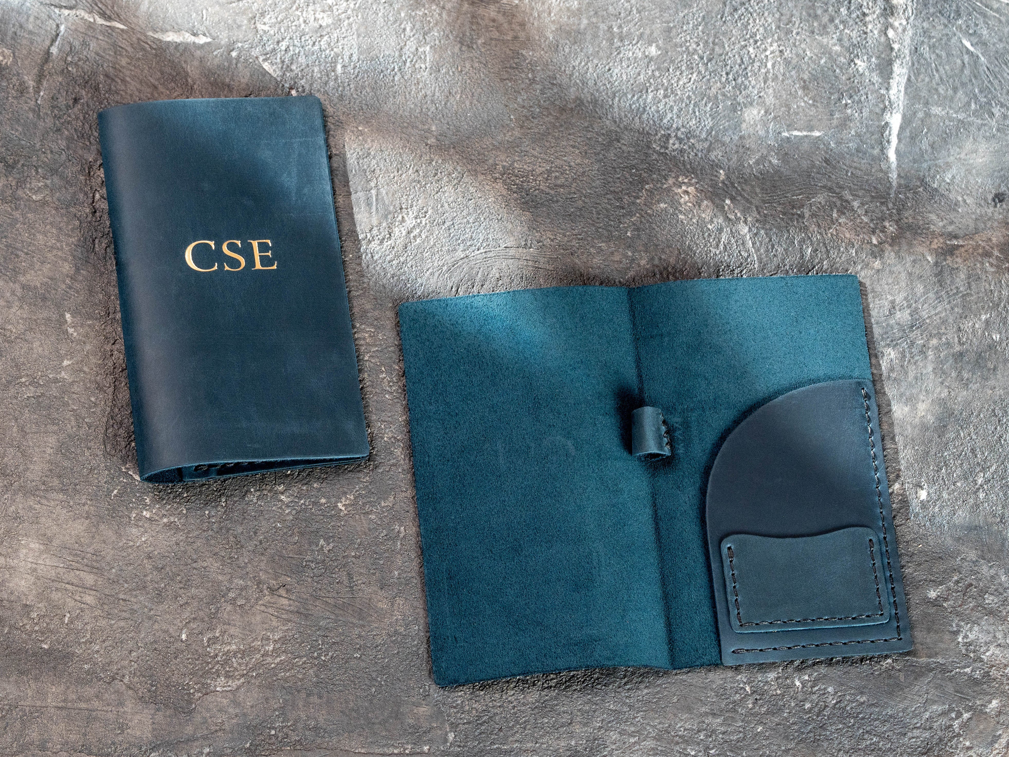 Blue leather check presenter open to show card pocket, receipt pocket and pen loop