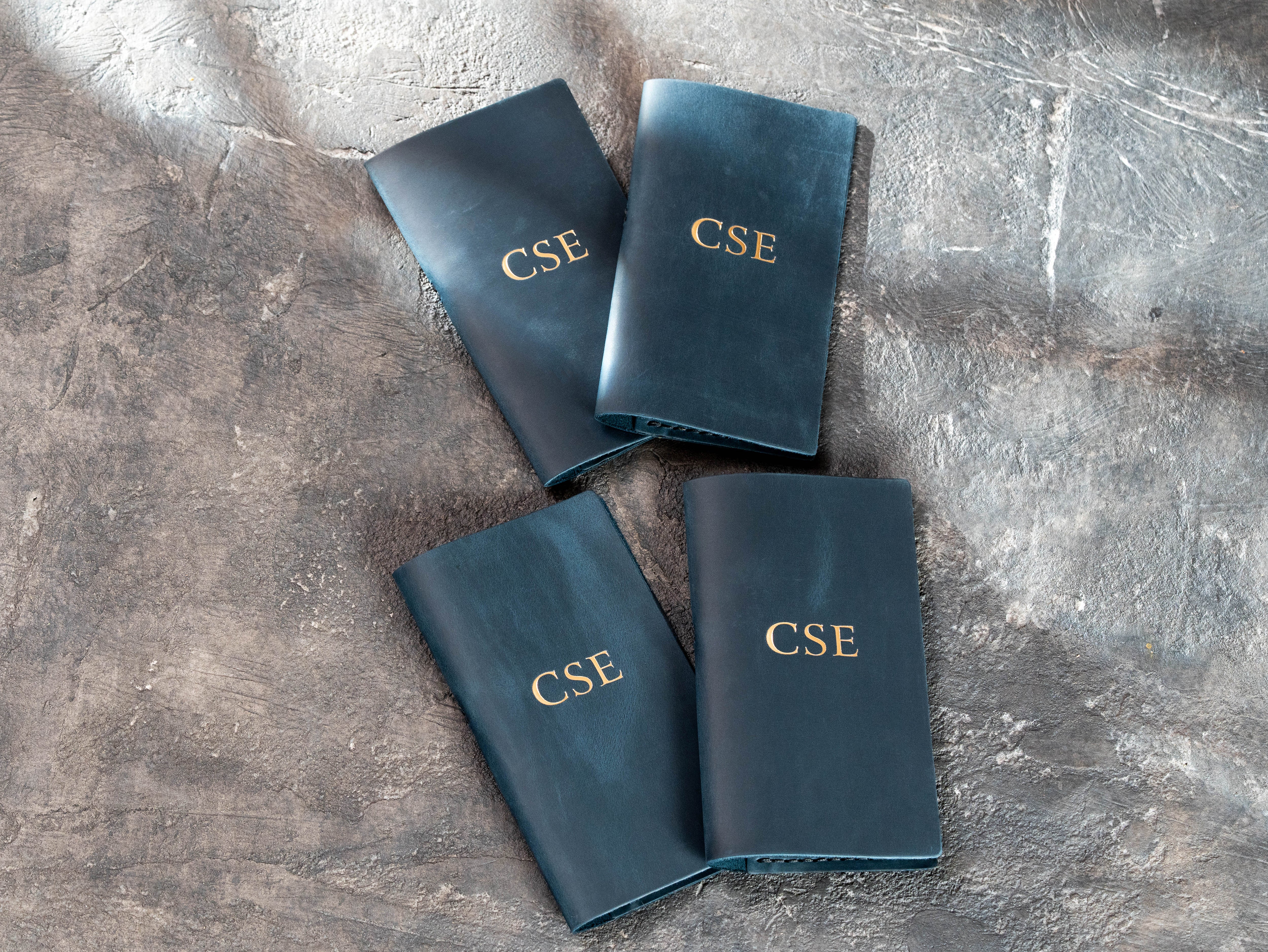 4 personalized blue leather restaurant check presenters with gold initials