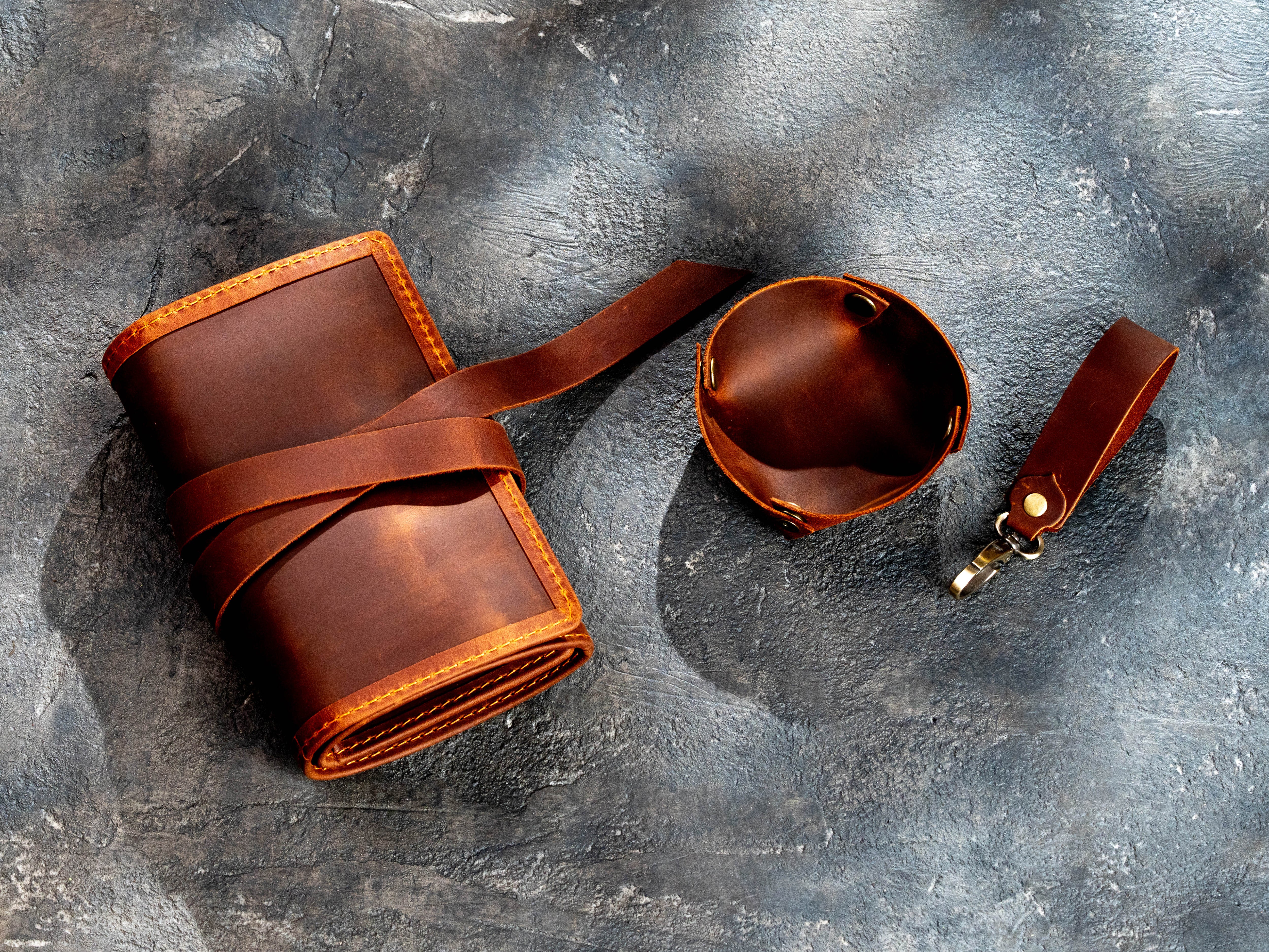 Brown leather pipe roll with snap-button tobacco tray and detachable pipe stand laid flat