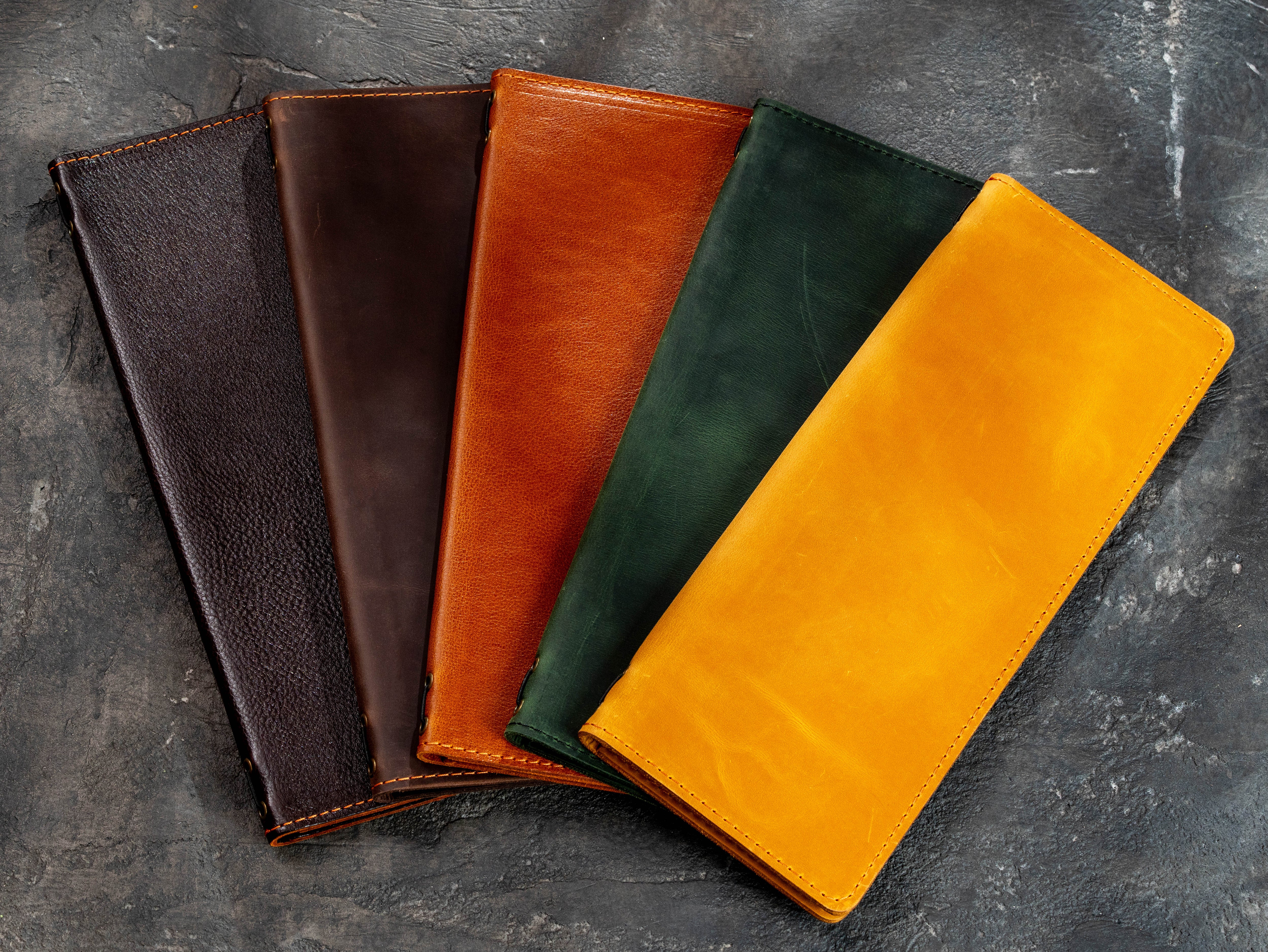 Leather wine list cover in multiple custom colors with an open brown bar menu in front