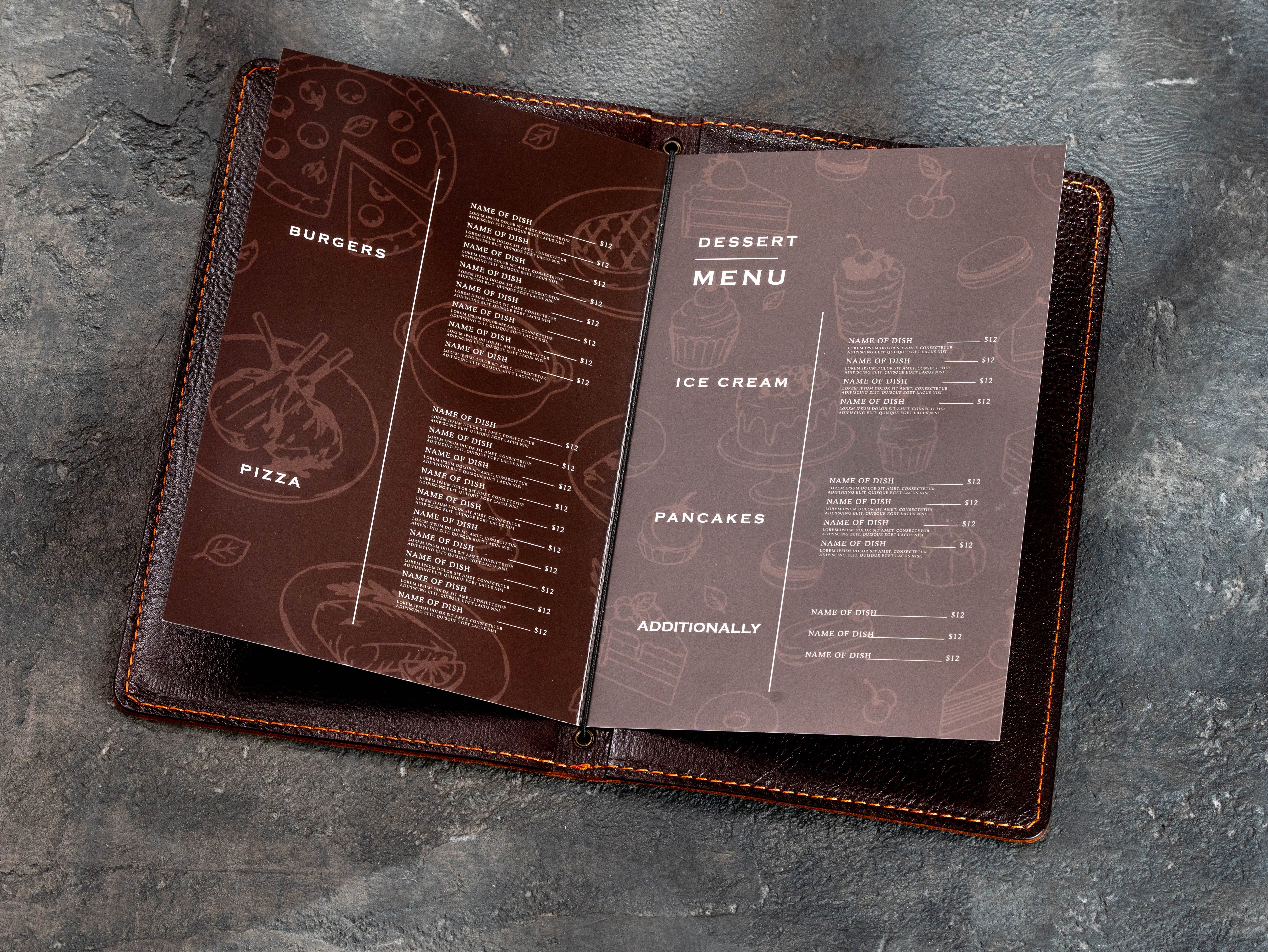 Open cognac leather restaurant menu cover with printed food menu pages secured by a central elastic cord