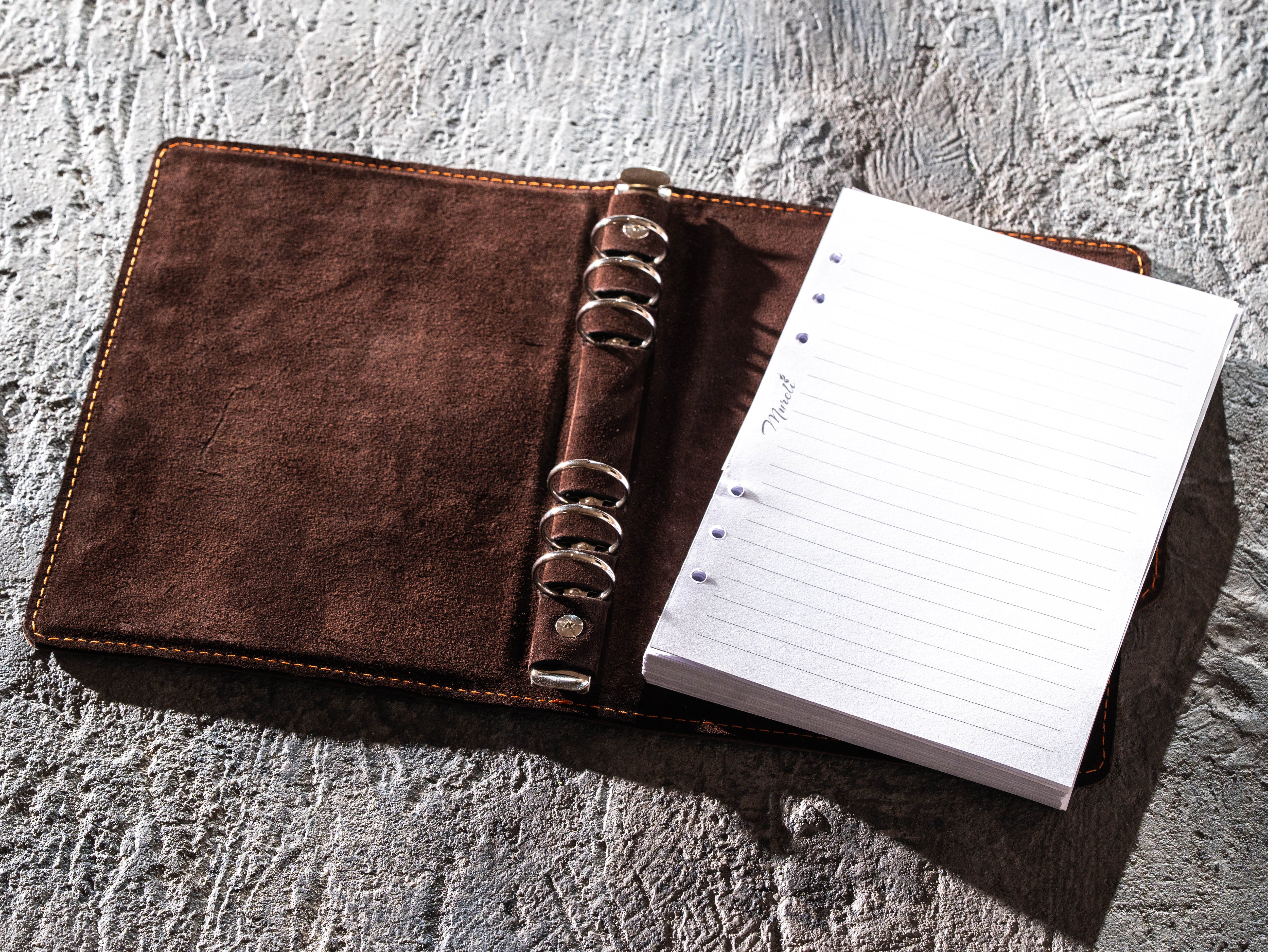 Open dark brown leather six-ring binder with refillable A5 lined pages