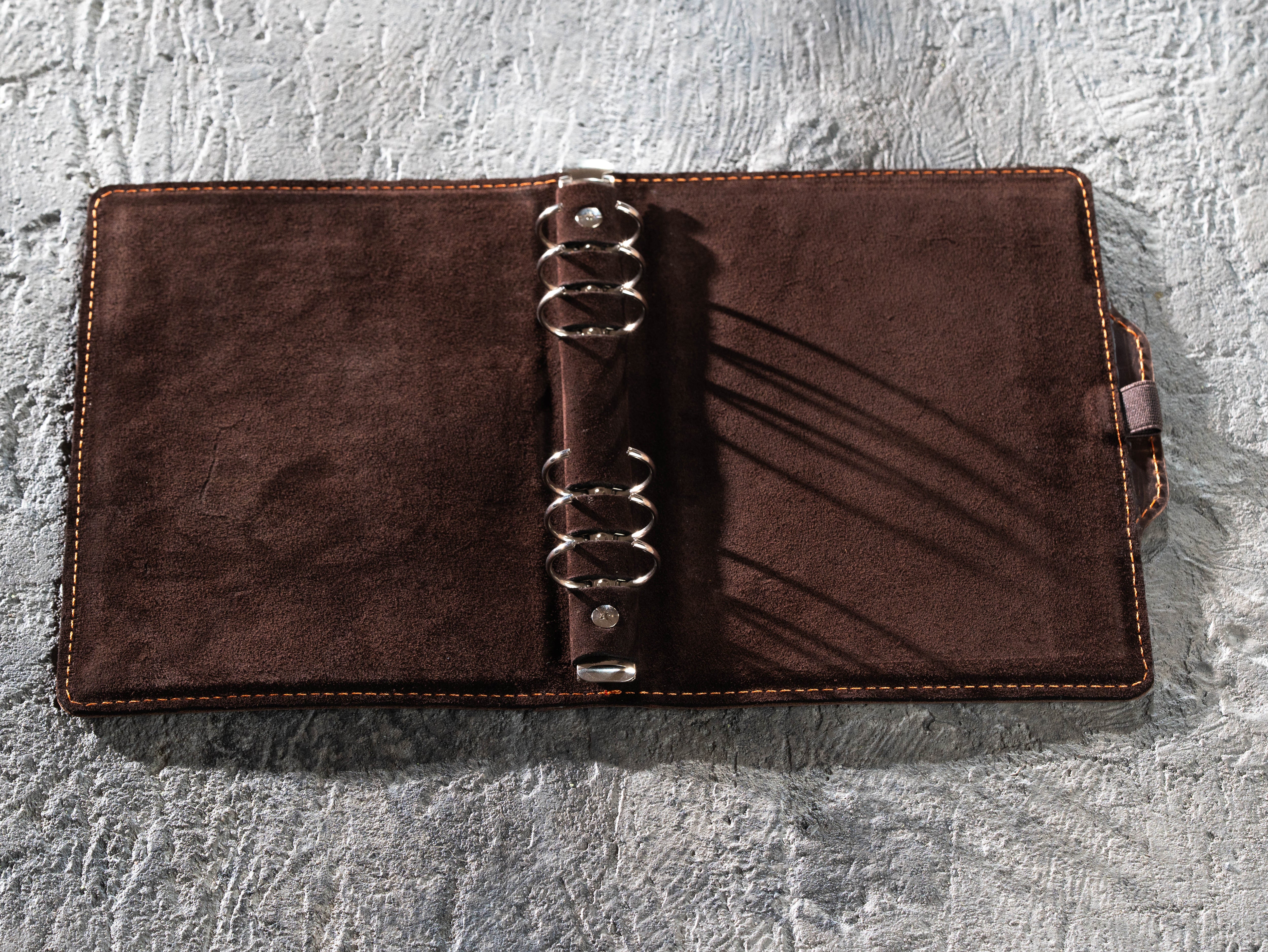 Open dark brown leather A5 six-ring binder cover with side pen holder and soft interior