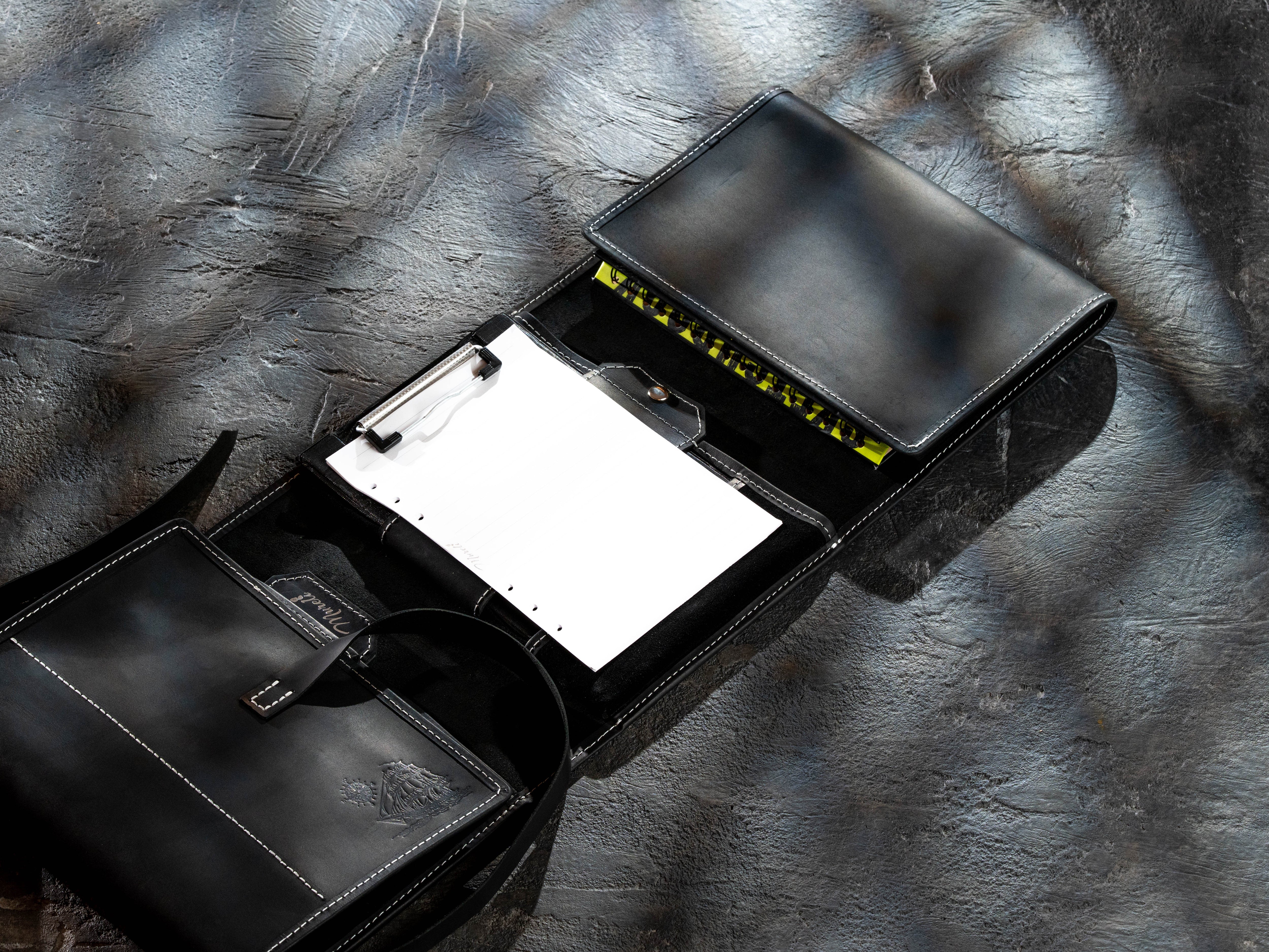 Black leather artist organizer arranged with an A5 clipboard and additional notebook storage
