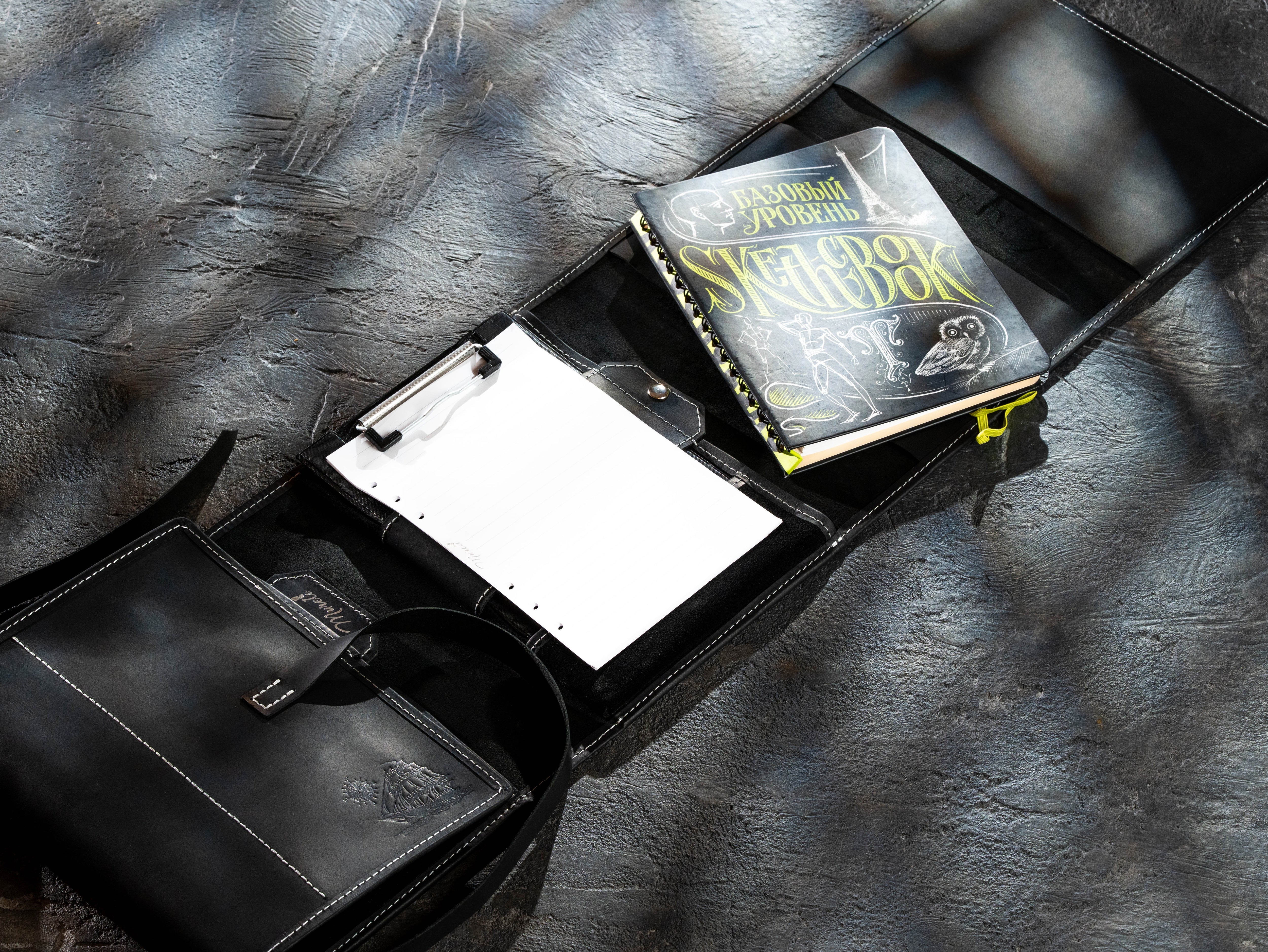 Black leather creative organizer with sketchbooks, clipboard and wide desktop layout