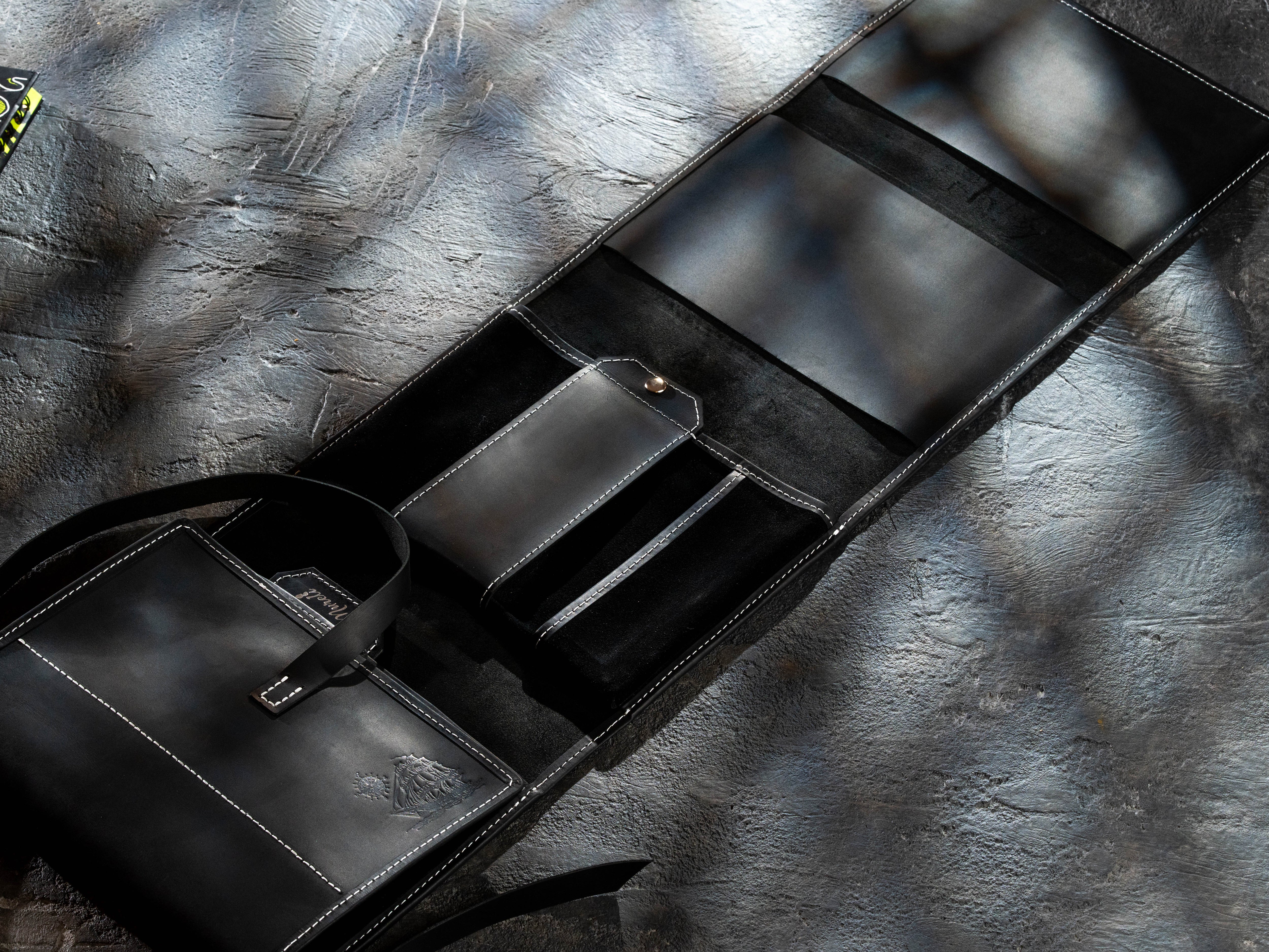 Open black leather artist organizer with large pockets for notebooks, paper and art materials