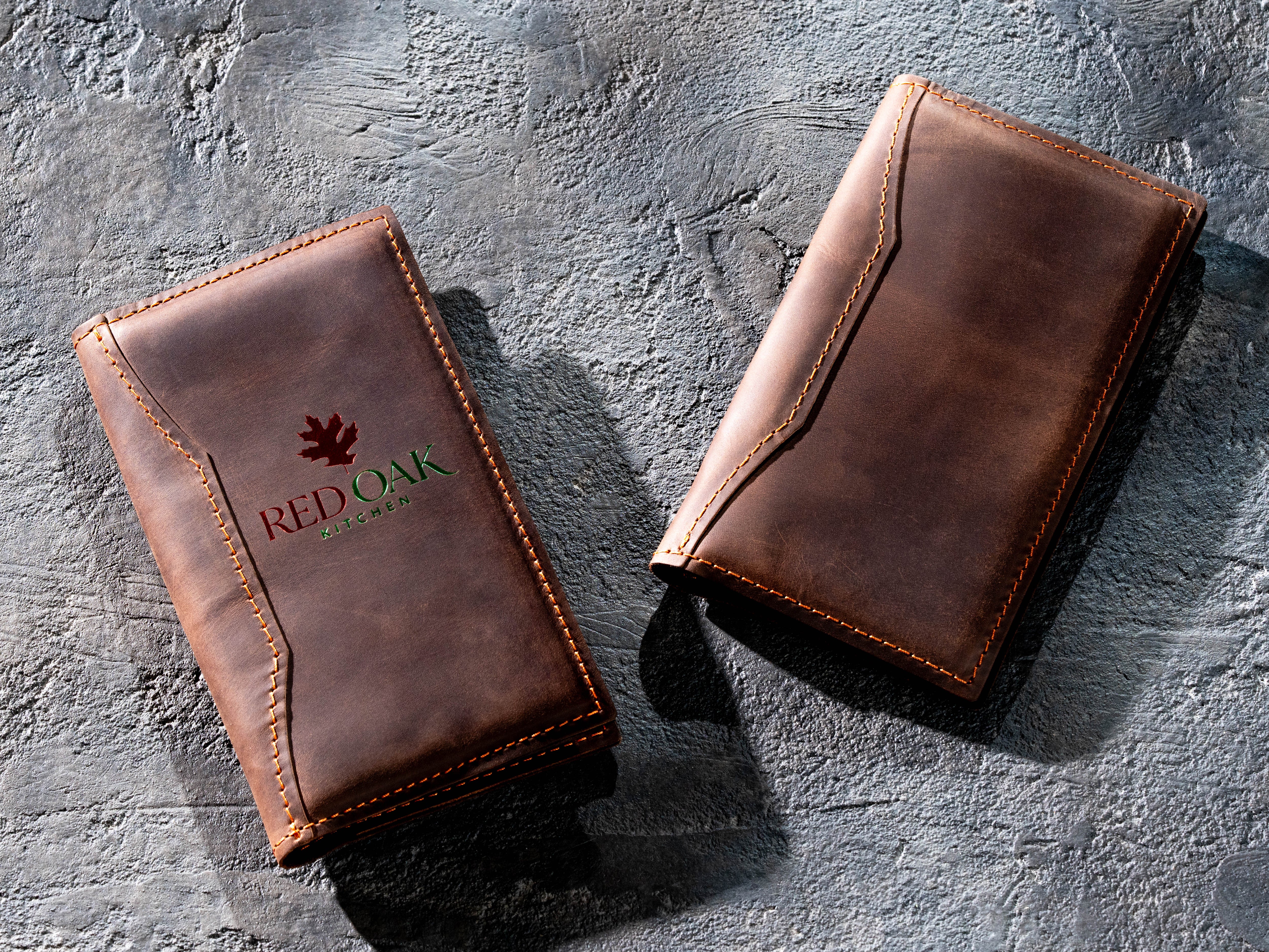 Two brown leather check presenters displaying branded and unbranded front covers