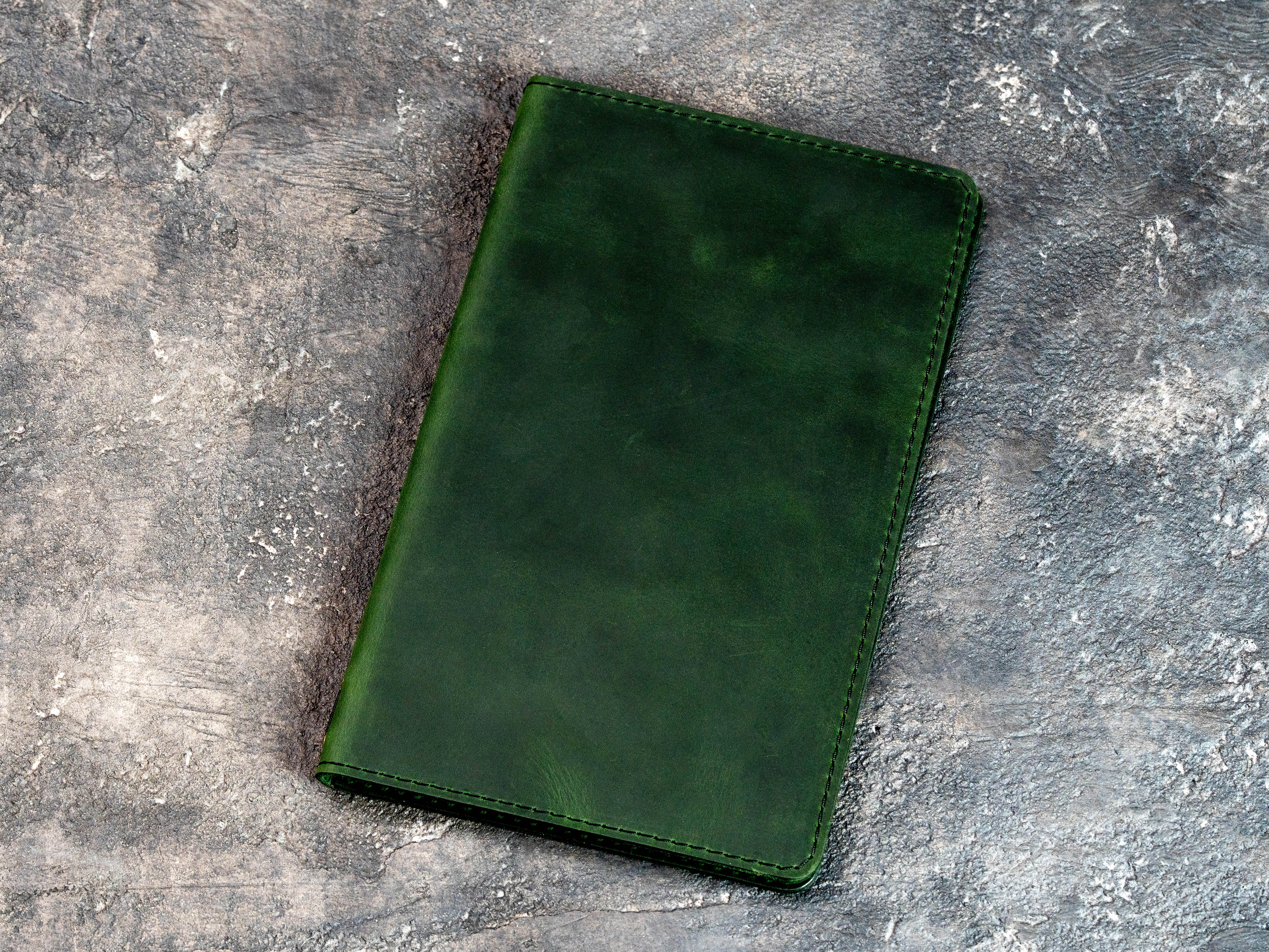 Green leather menu cover in closed and open views for standard restaurant menu pages