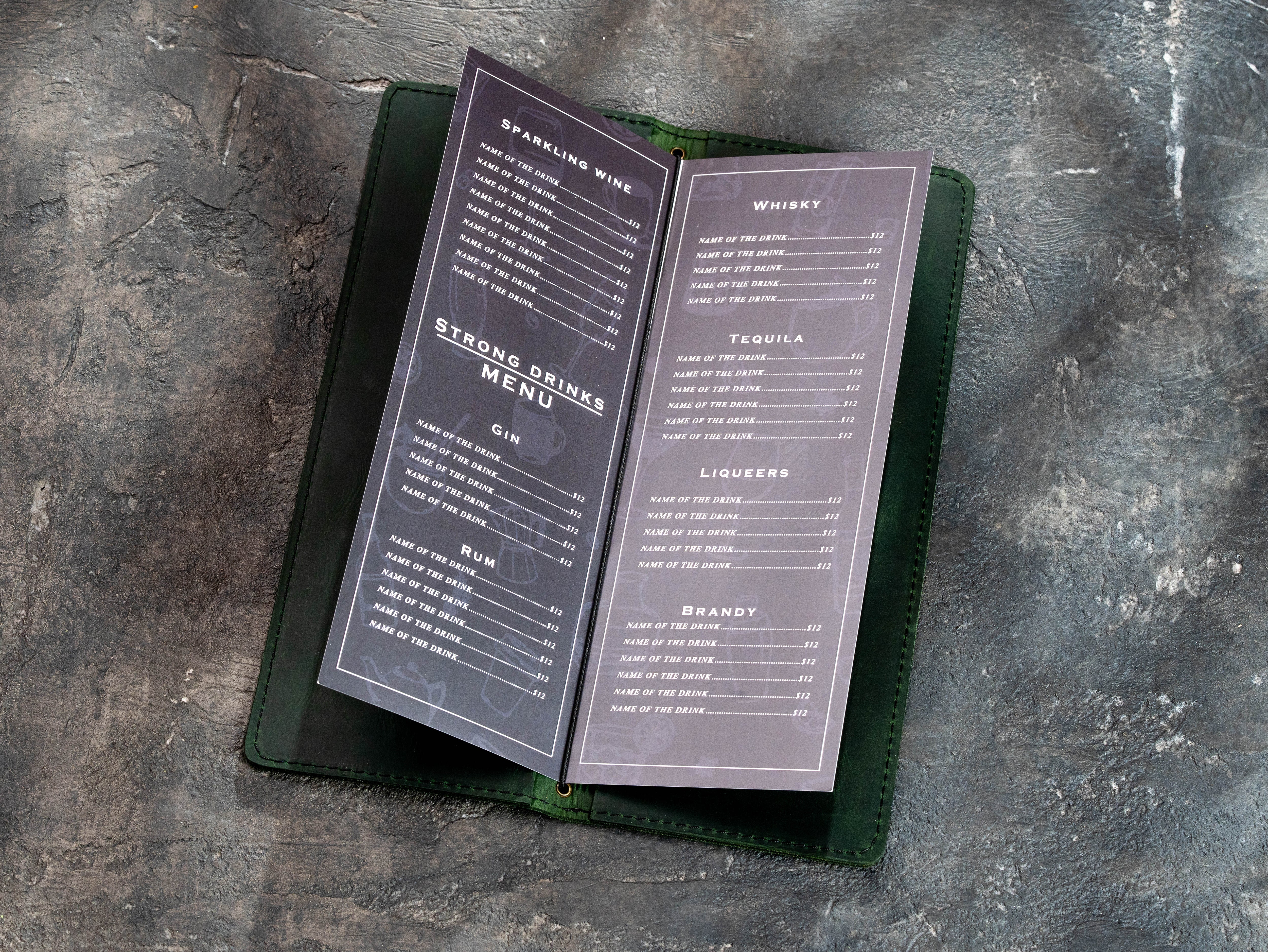Green leather wine and bar menu cover with printed drink pages secured by elastic cord