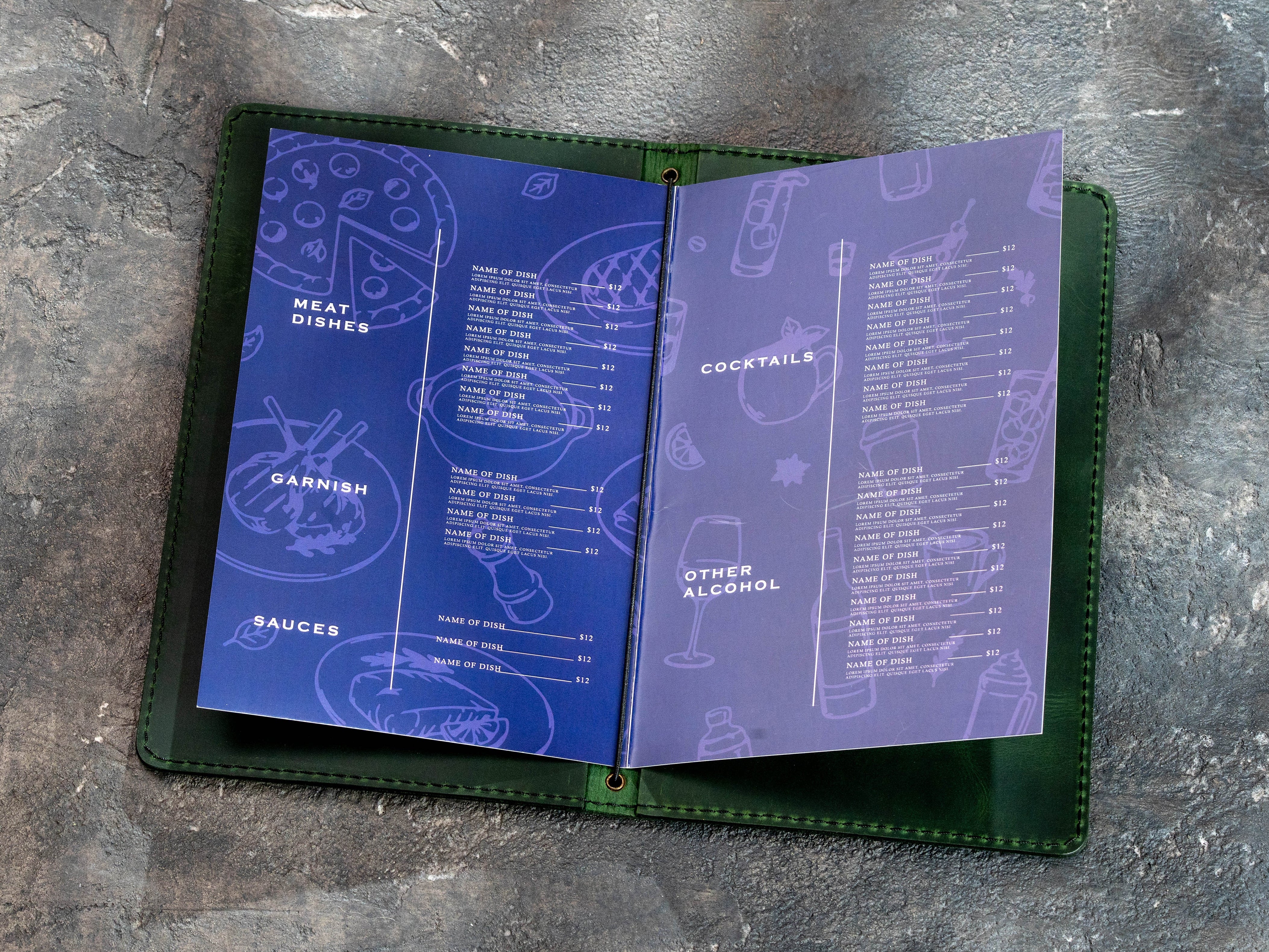 Open green leather menu cover with folded 8.5 × 11 inch menu pages secured by an elastic cord