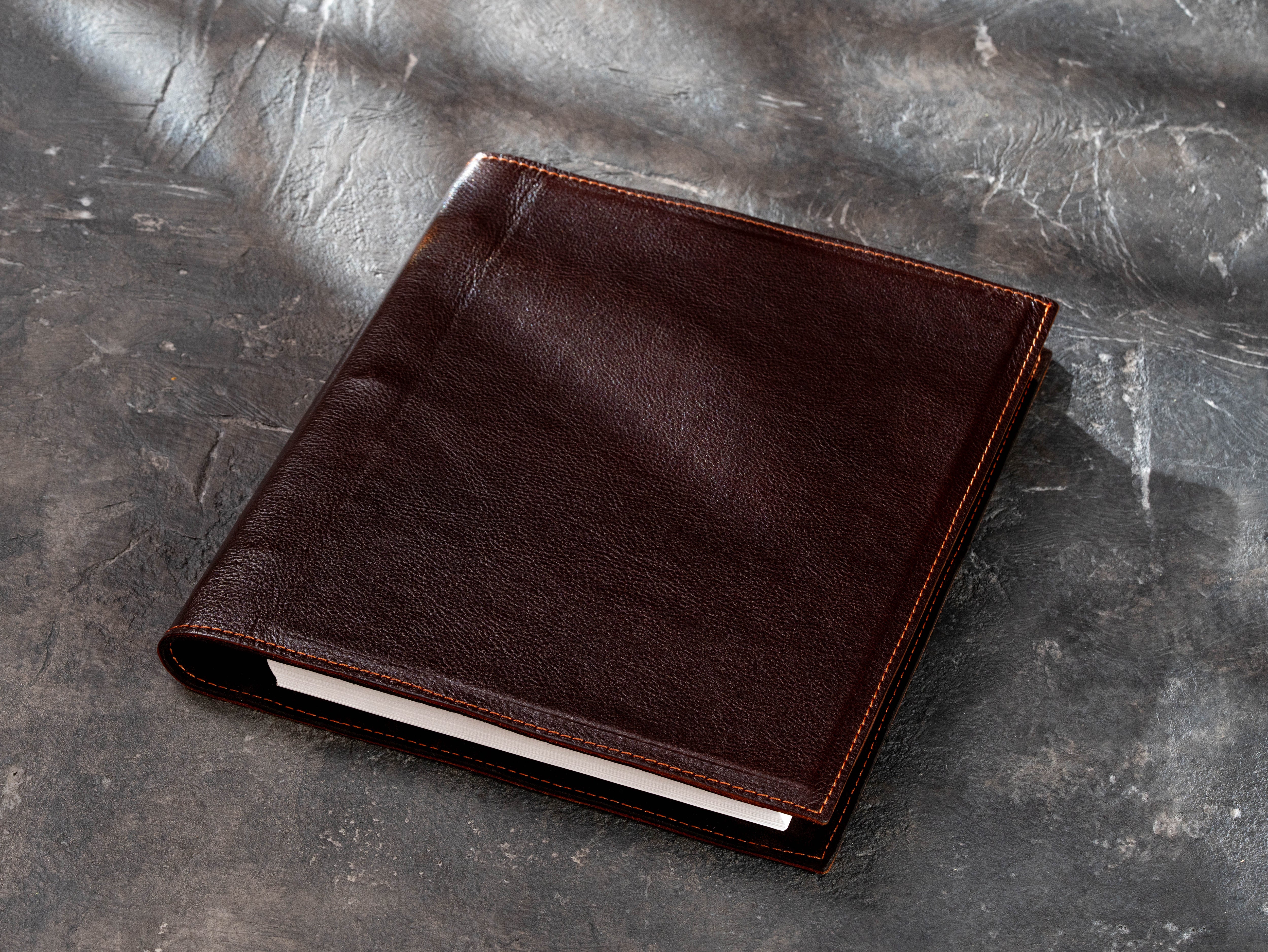 dark brown leather 3-ring binder for 8.5 × 11 inch paper with rigid construction and stitched edges