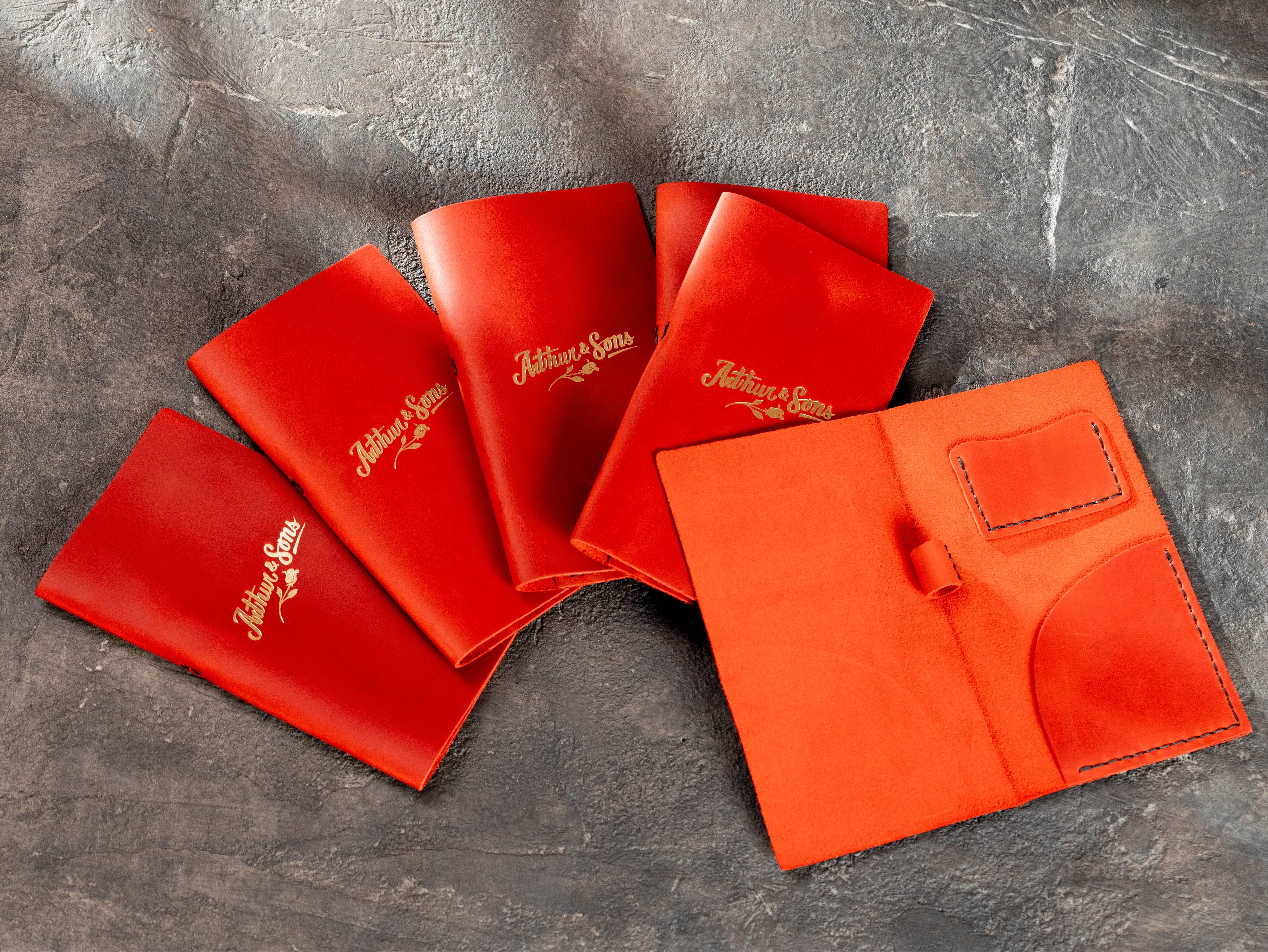 Custom red leather bill holders with gold logo and interior card pocket, restaurant order by Mureli Workshop